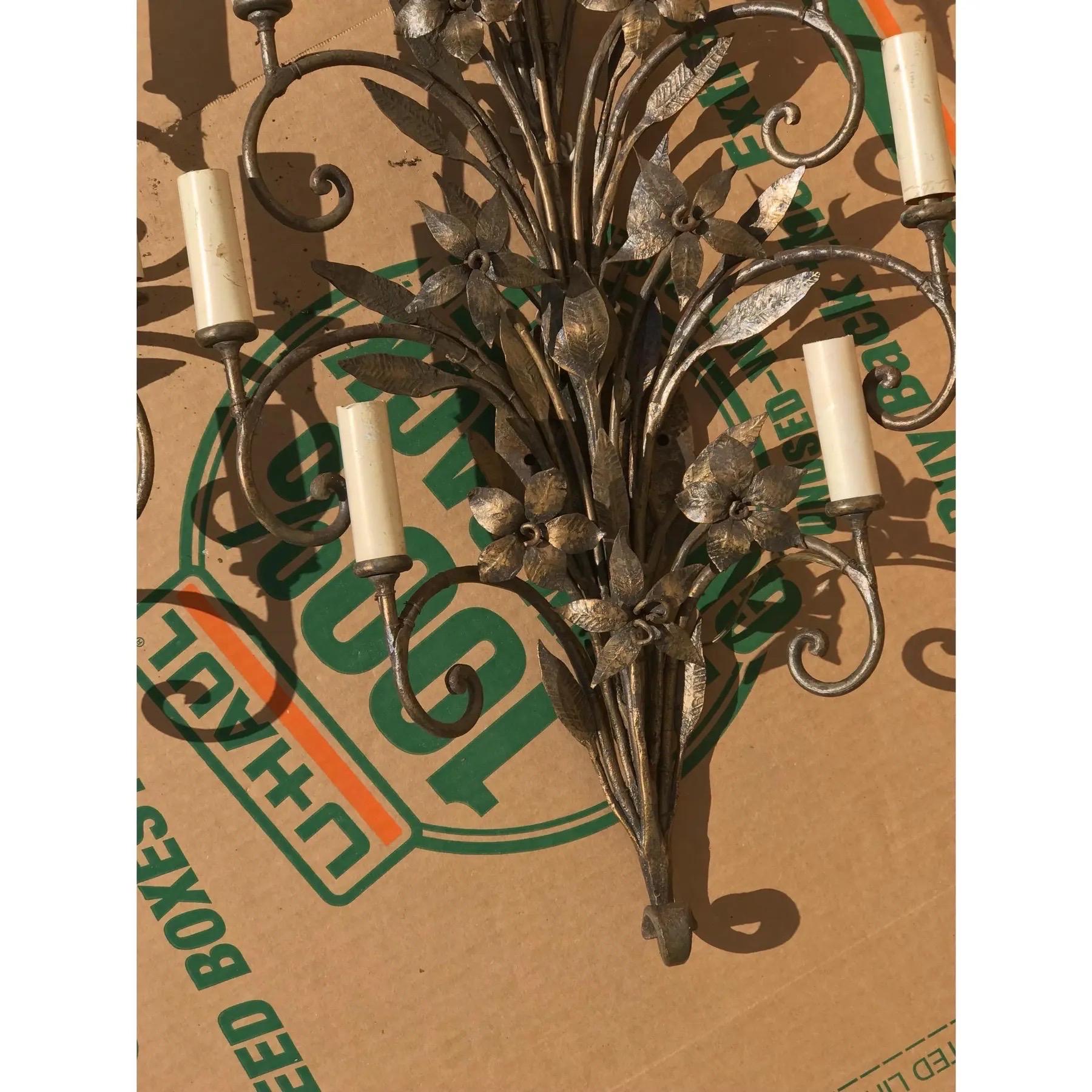 A beautiful pair of Art Nouveau period wall sconces made of wrought iron. Eight scrolled arms are decorated with flowers and foliage. Recently rewired.