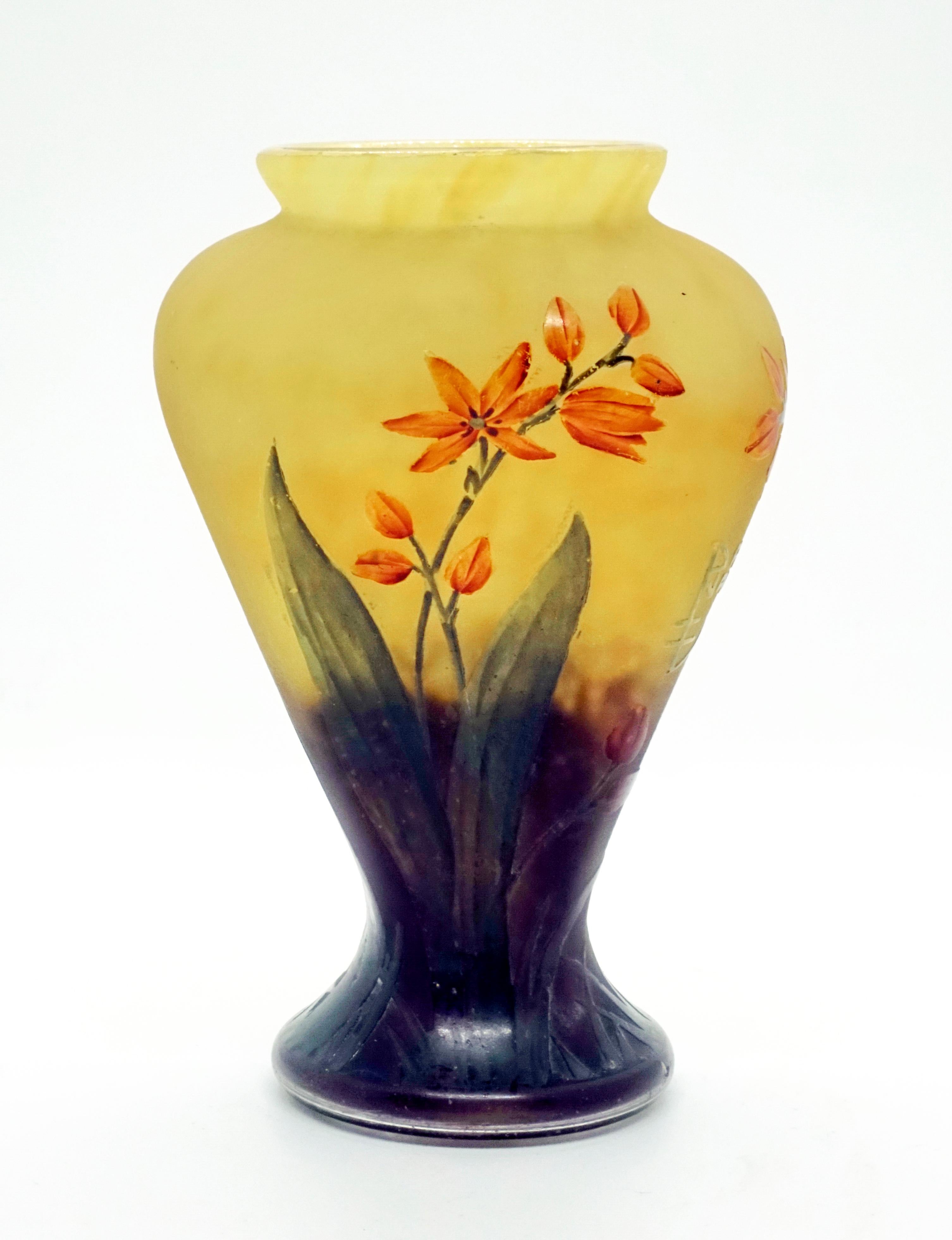 Small baluster vase, pressed in four times, on a round base, colorless glass with powder melts in opaque lemon yellow, in the area of the stand in violet, satined surface with etched and colored enamel floral decoration, in orange-red and green