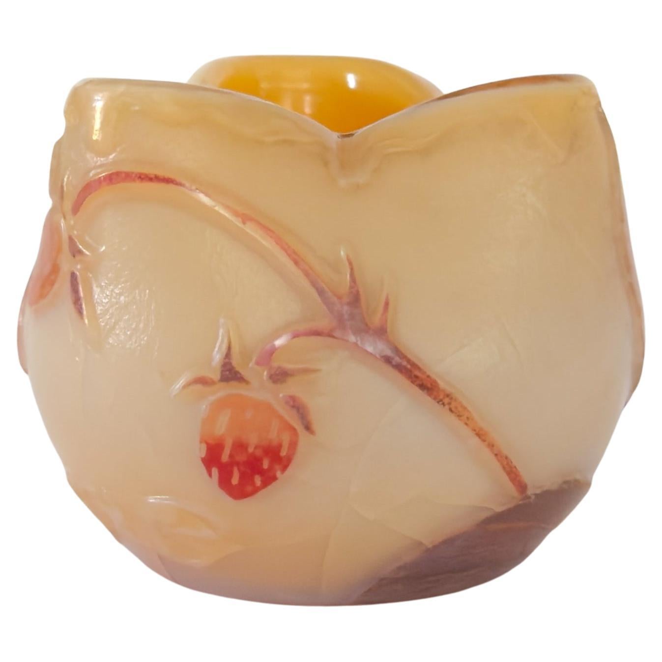 This petite Art Nouveau vase, designed by François-Théodore Legras and produced by Verrerie Legras, features a rounded form with a fluted organic opening, evoking a blossoming strawberry tree fruit. 
Rendered in delicate shades of yellow, orange,