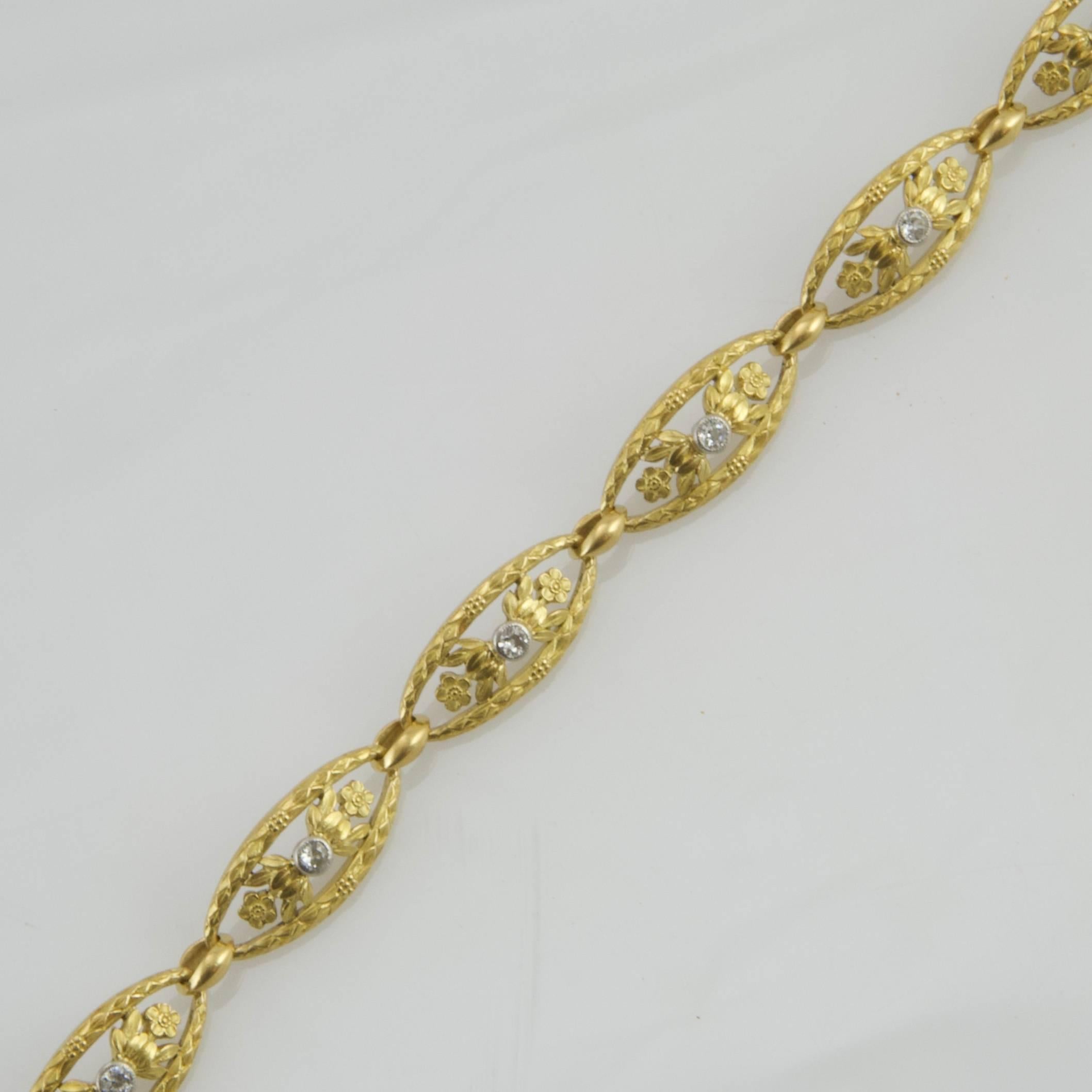Open weave yellow gold bracelet, composed by eight chiseled links flower patterned. Each link of elongated form set with a antique-cut diamond ( approx: 0.10ct)
Made in France around 1900. 
Maker's mark:  Maître LG. Unknown. 
French assay mark. 
 