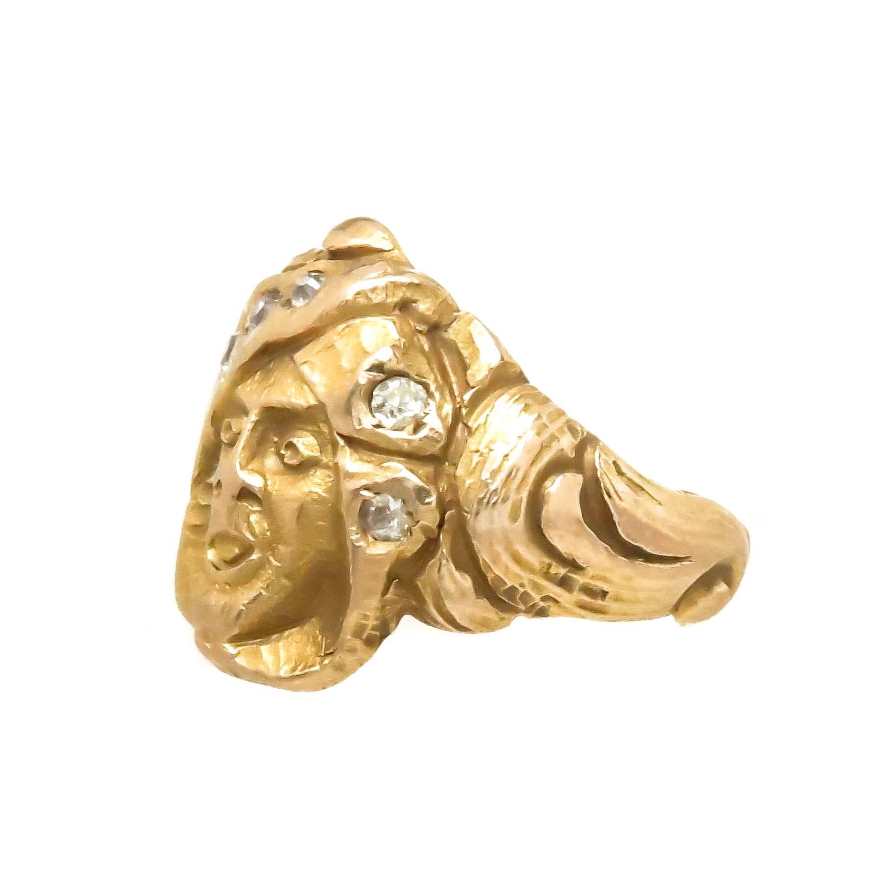 Circa 1910 Art Nouveau 14K Yellow Gold Face Ring, appearing to be a Man in a headdress that is set with old cut Diamonds.  The top of the ring measures 3/4 X 3/4 inch, excellent crisp condition with detailed hand chased Gold Workmanship. Finger size