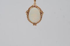Art Nouveau Yellow Gold Pendant with Opal, Diamonds, and Rubies