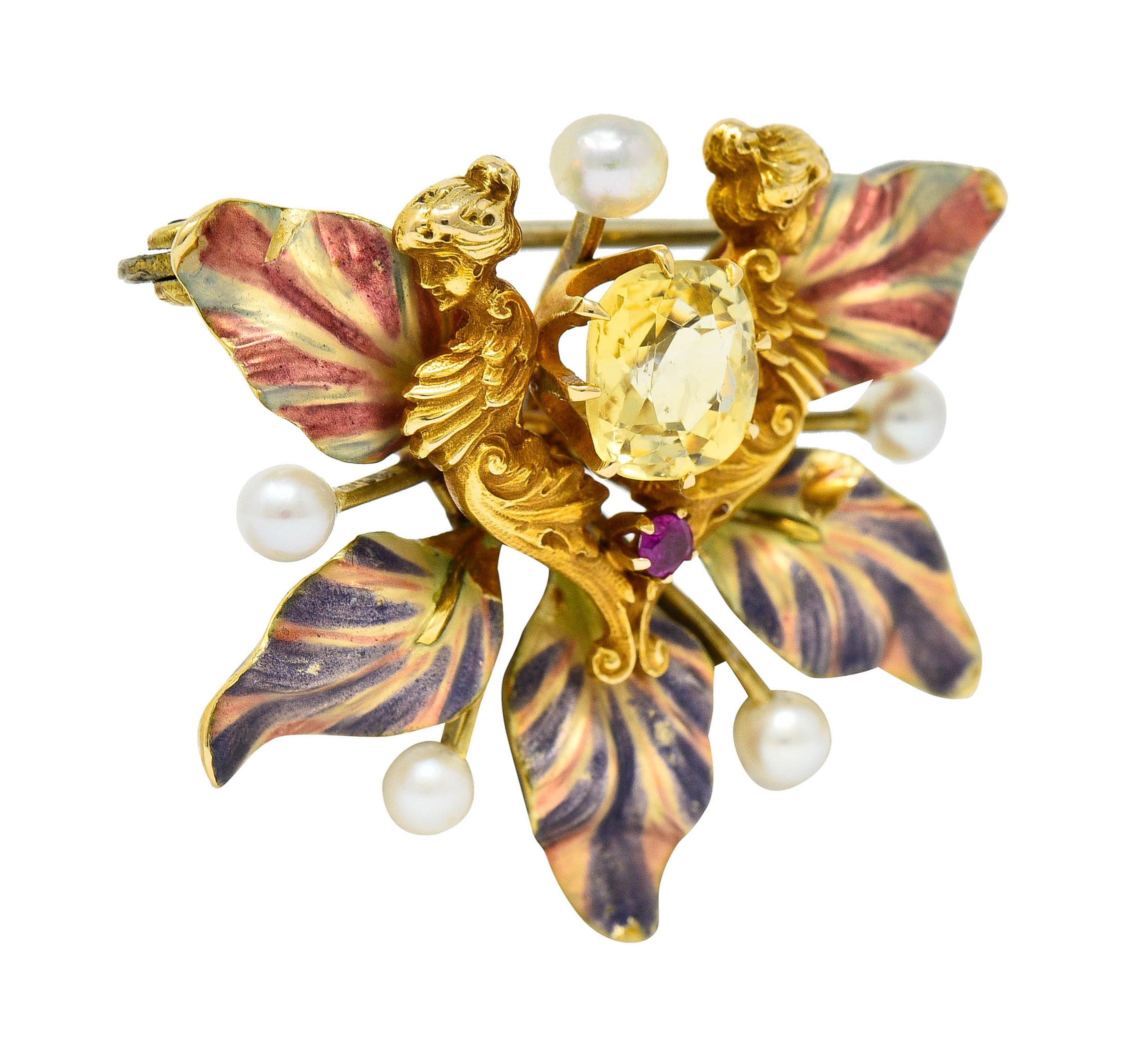 Brooch is ornately rendered as two mirrored womanly figures with whiplashed details surrounded by undulating petals

Petals are glossed with pink and purple enamel that exhibits some loss - consistent with age, wear, and use

Centering a cushion cut