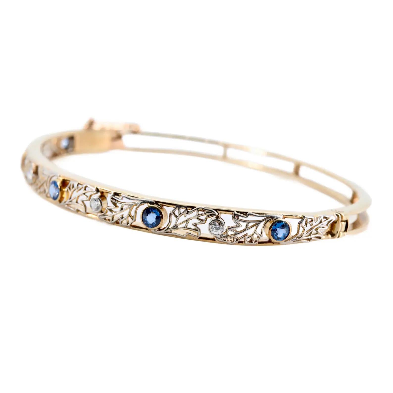 An art nouveau period platinum filigree leaf motif bangle bracelet. Set with five no heat Yogo Gulch, Montana sapphires of 0.25 carats a piece for a total sapphire weight of 1.25 carats. Accented by 0.16ctw of bezel set old European cut diamonds of