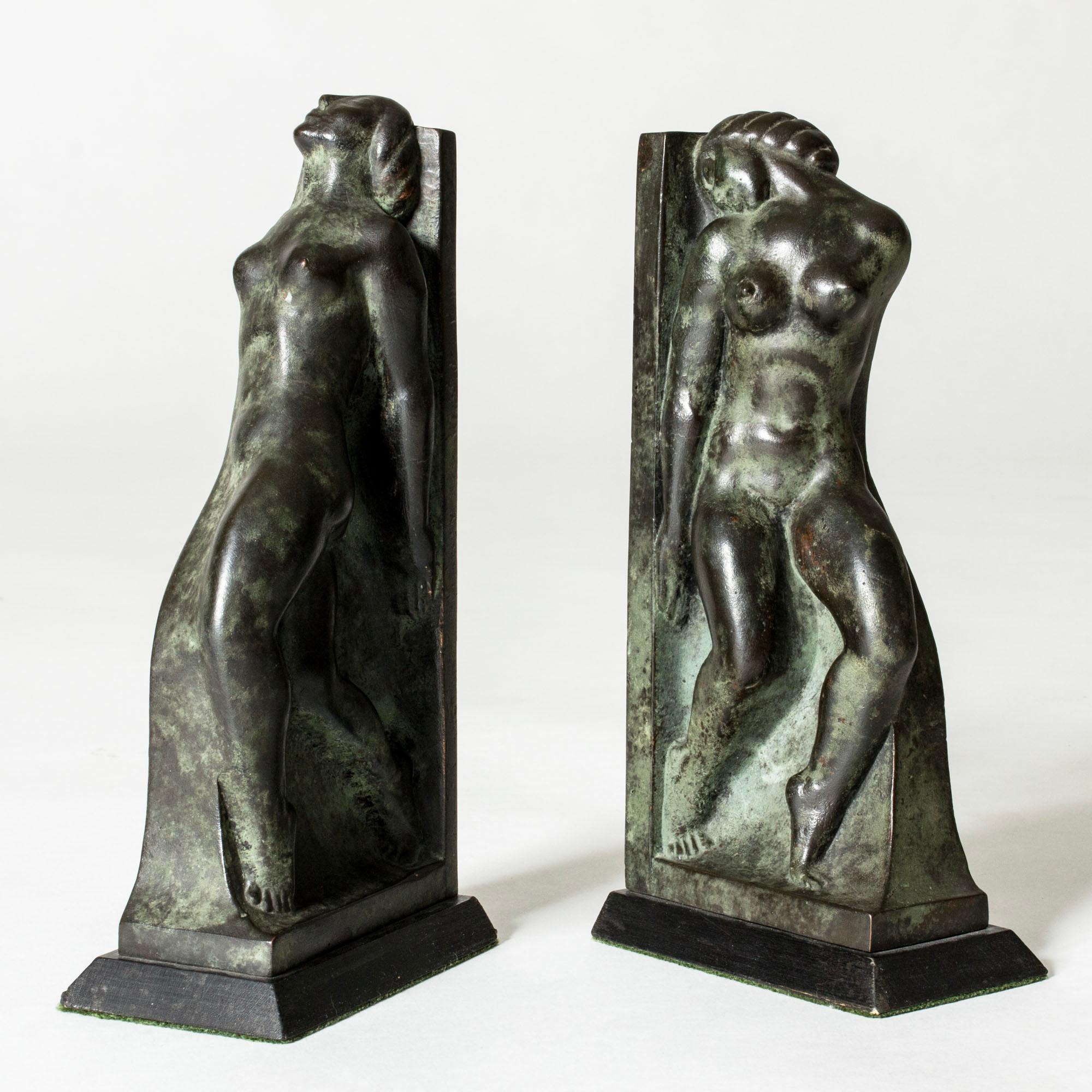 Pair of beautiful patinated bronze bookends by Axel Gute, in the form of women with swooning expressions. Very decorative and lovely attention to detail.