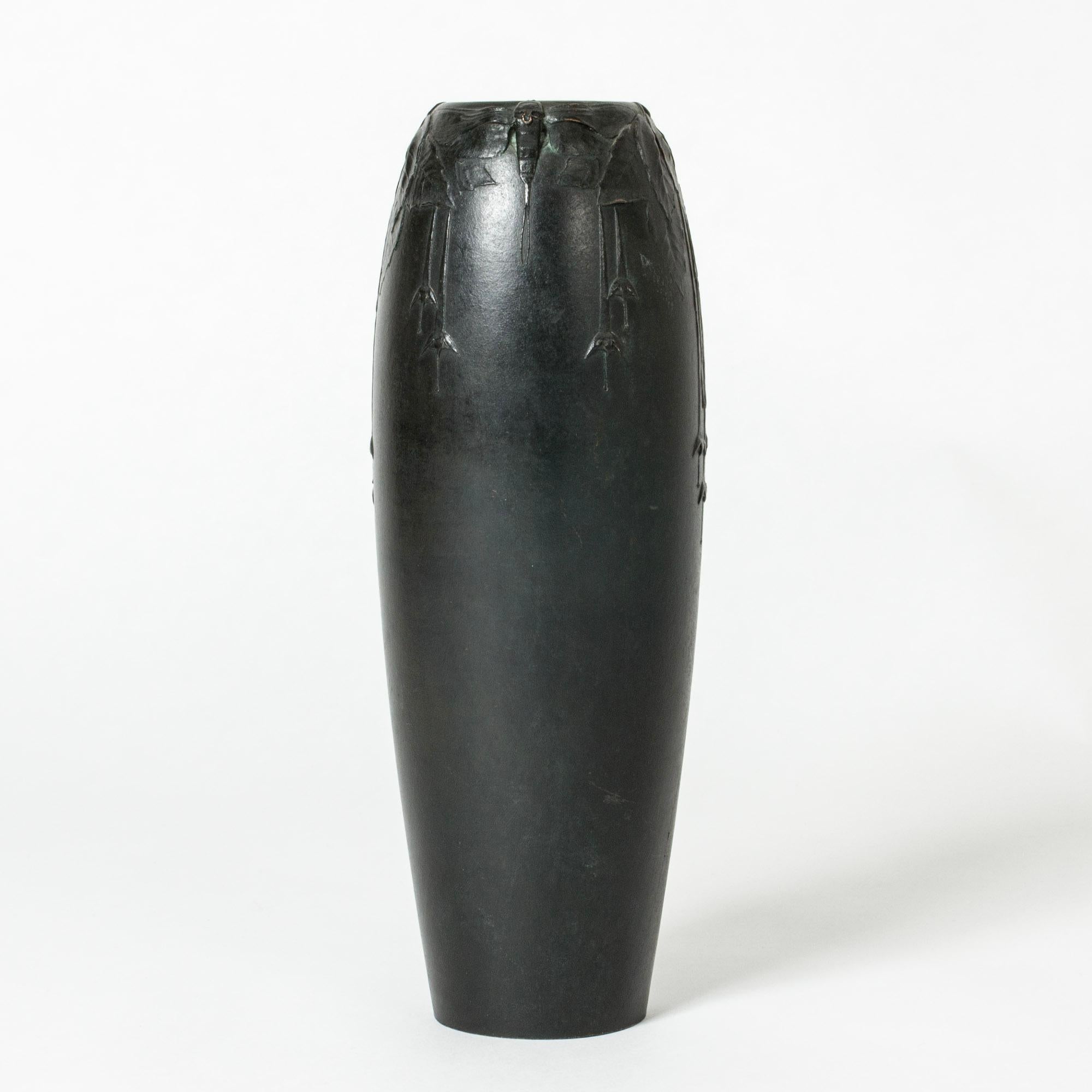 Beautiful Art Noveau vase in black patinated bronze, designed by Hugo Elmqvist. Elegant clean form with relief decor of leaves, flowers and dragonflies around the mouth.