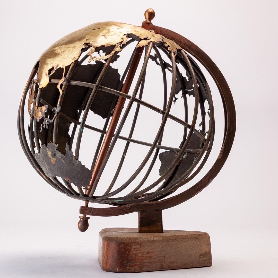 Art Object / sculpture depicting a  terrestrial globe, brass, wrought iron and teakwood. Origins from France/Belgium in the 1950-60ies. Unknown artist, and the piece carries no marks or signature,

Lattice construction made of iron struts. Finely