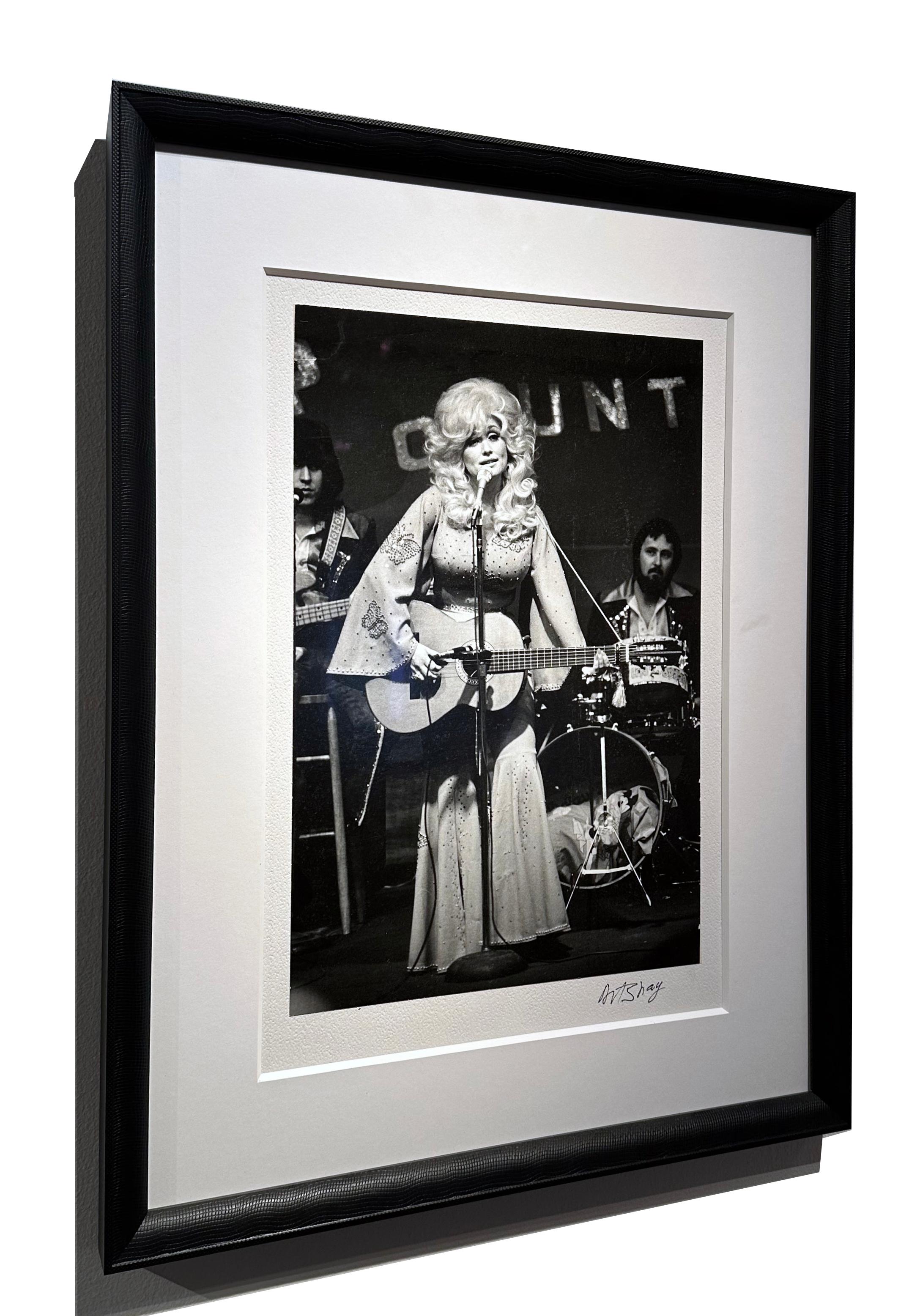 **This artwork is on exhibition and if purchased will be available to ship after June 15, 2025

The incomparable Dolly Parton doing what she does best, performing. In this vintage silver gelatin print by famed photographer Art Shay, she is dressed