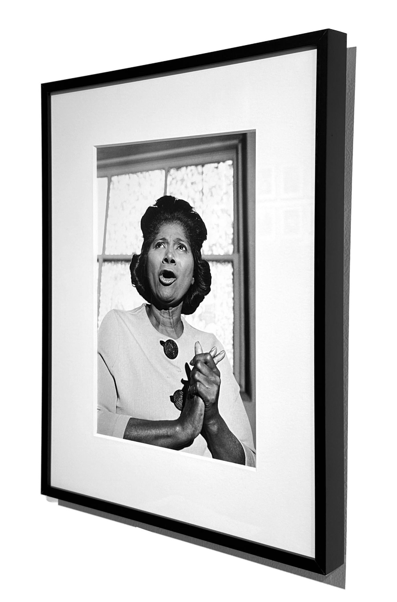 Art Shay photographed Mahalia Jackson singing-in-motion in the basement of her house in the late 1950's.  His image captures Jackson's dynamic approach to music as a form of personal liberation.  