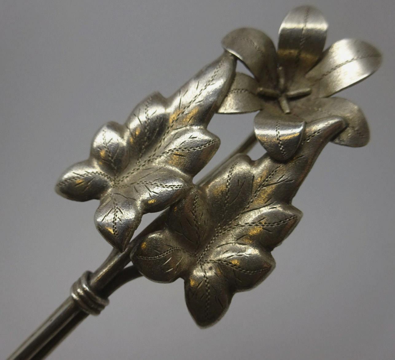 Coin silver (unmarked) berry spoon with gold-washed, bright-cut bowl, and 3D flower and leaf motif and wire style handle, 8 3/4