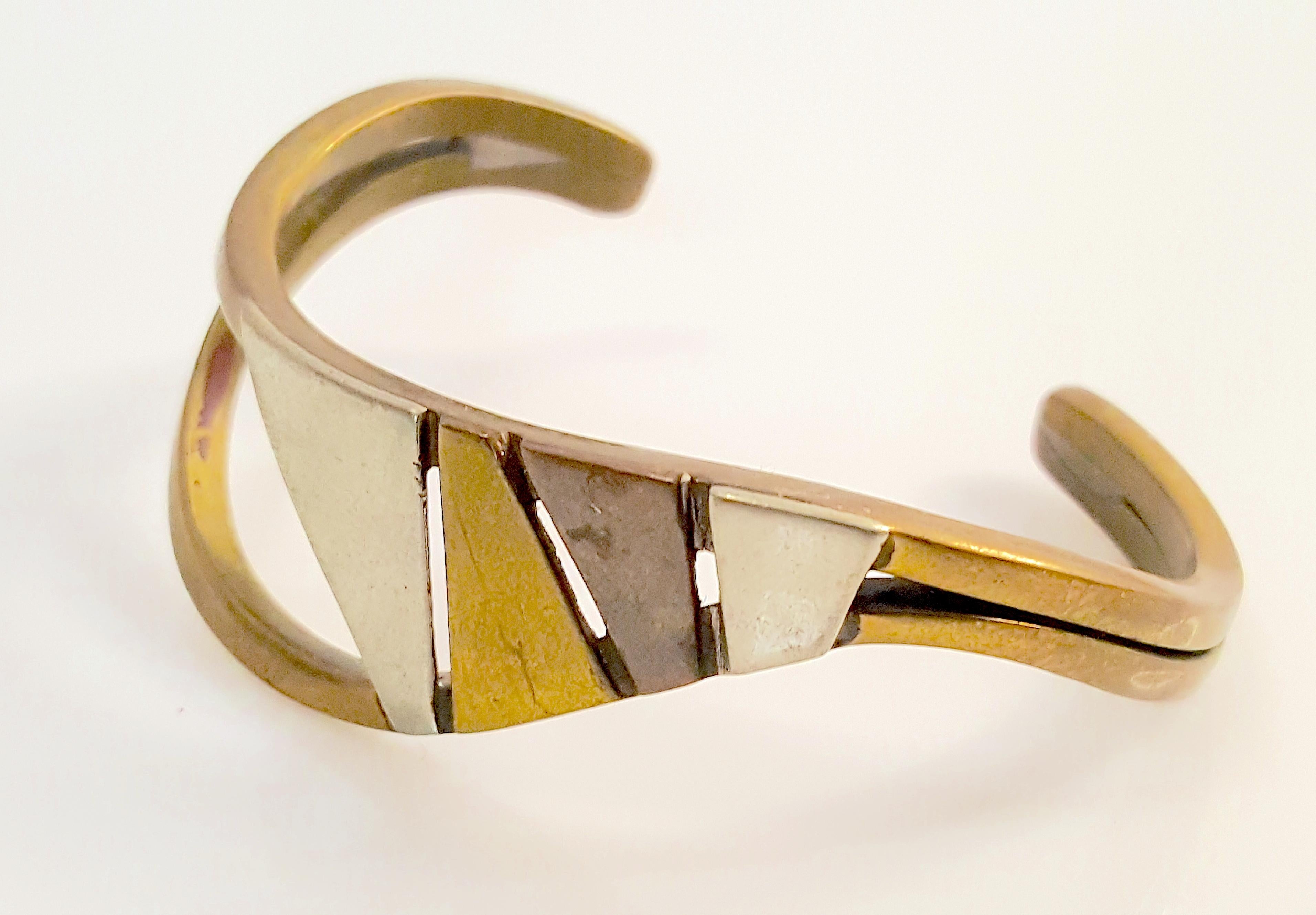 American Art Smith hand-crafted this modern asymmetrical cuff from roughly finished semi-precious layered metals in his early signature style including sculptural wires and gaps. On the top of the bracelet that displays Smith's dynamic artistry,