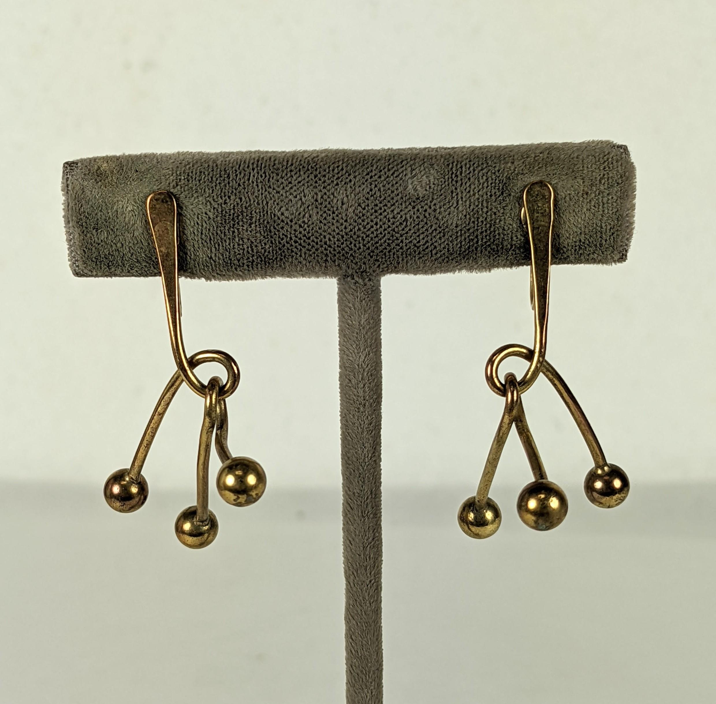 Art Smith Modernist Mobile Earrings in brass from the 1950's. Athough unsigned, this is a well recognized design of his (see Brooklyn Museum Collection) and the metal earring fixtures are correct as well. Designed as Art for your face, these mini