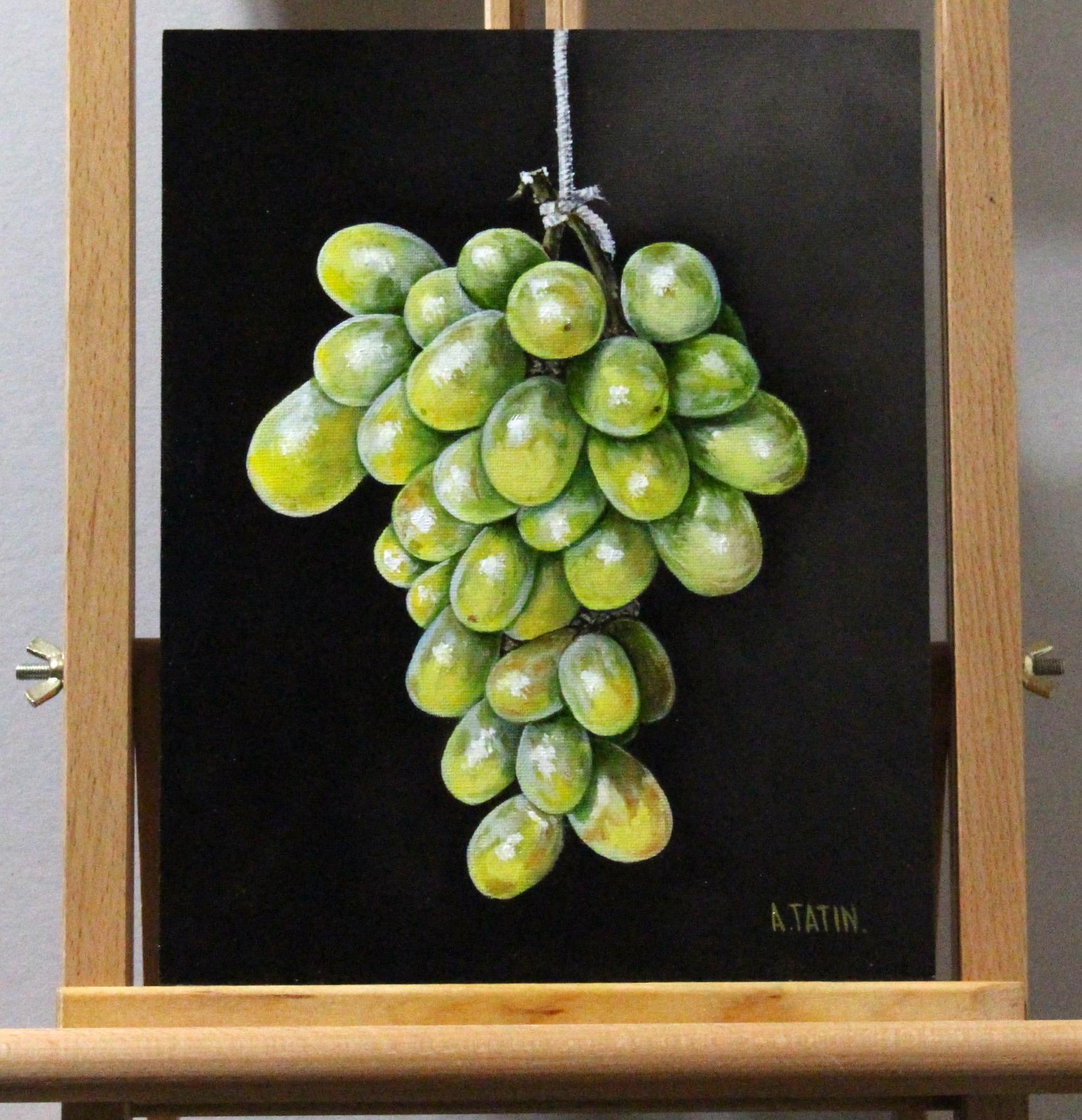 <p>Artist Comments<br />A cluster of green winter grapes hangs from a single stem, standing out against a stark black background. Each grape displays lifelike quality, with light reflections highlighting their smooth, plump forms. The shadows