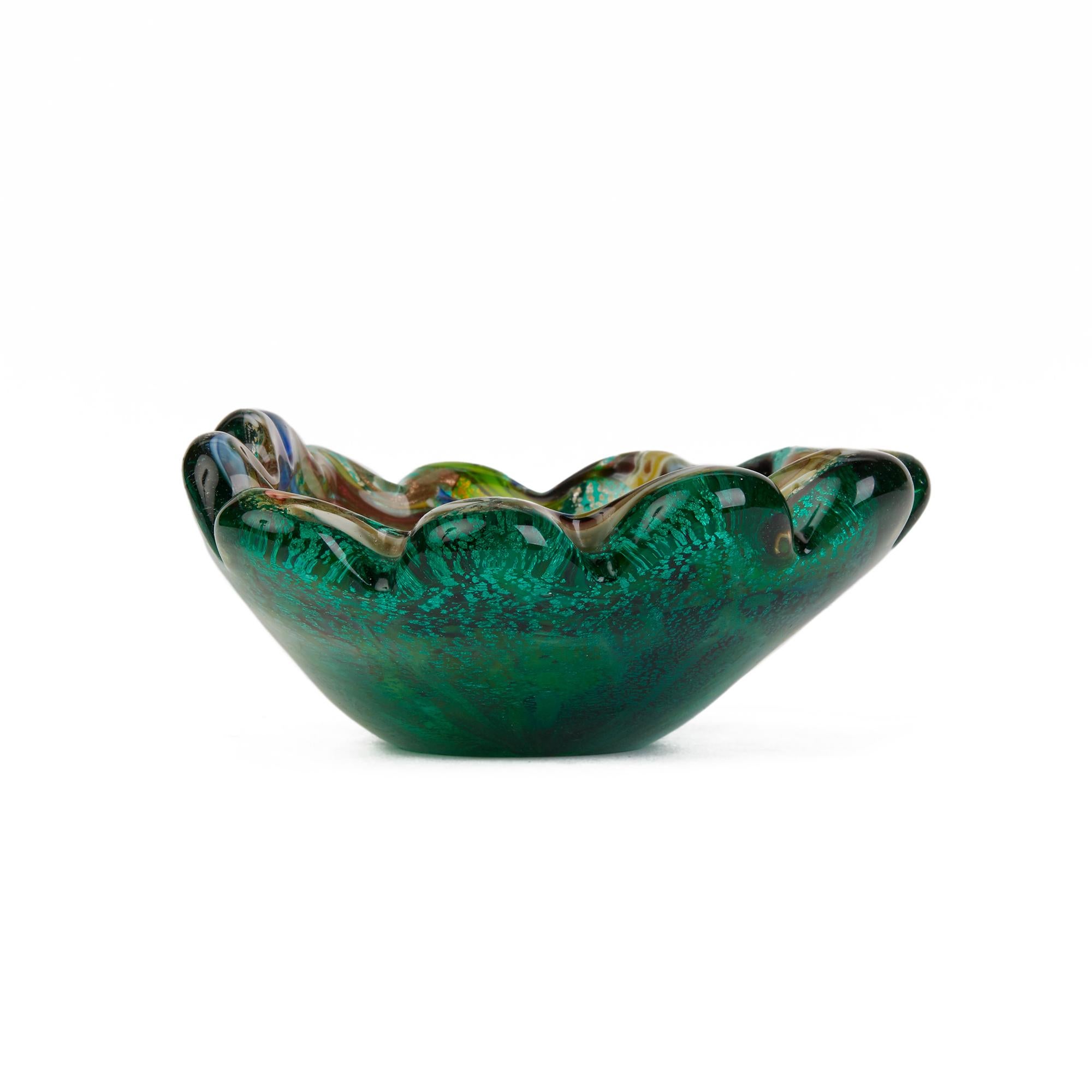 A stunning vintage Italian Murano Arte Vetrairia Muranese (AVEM) tutti frutti green glass dish of clam shell shape the inner bowl decorated with zanfirico polychrome and filigree canes on a scattered silver aventurine ground. The bowl is thickly