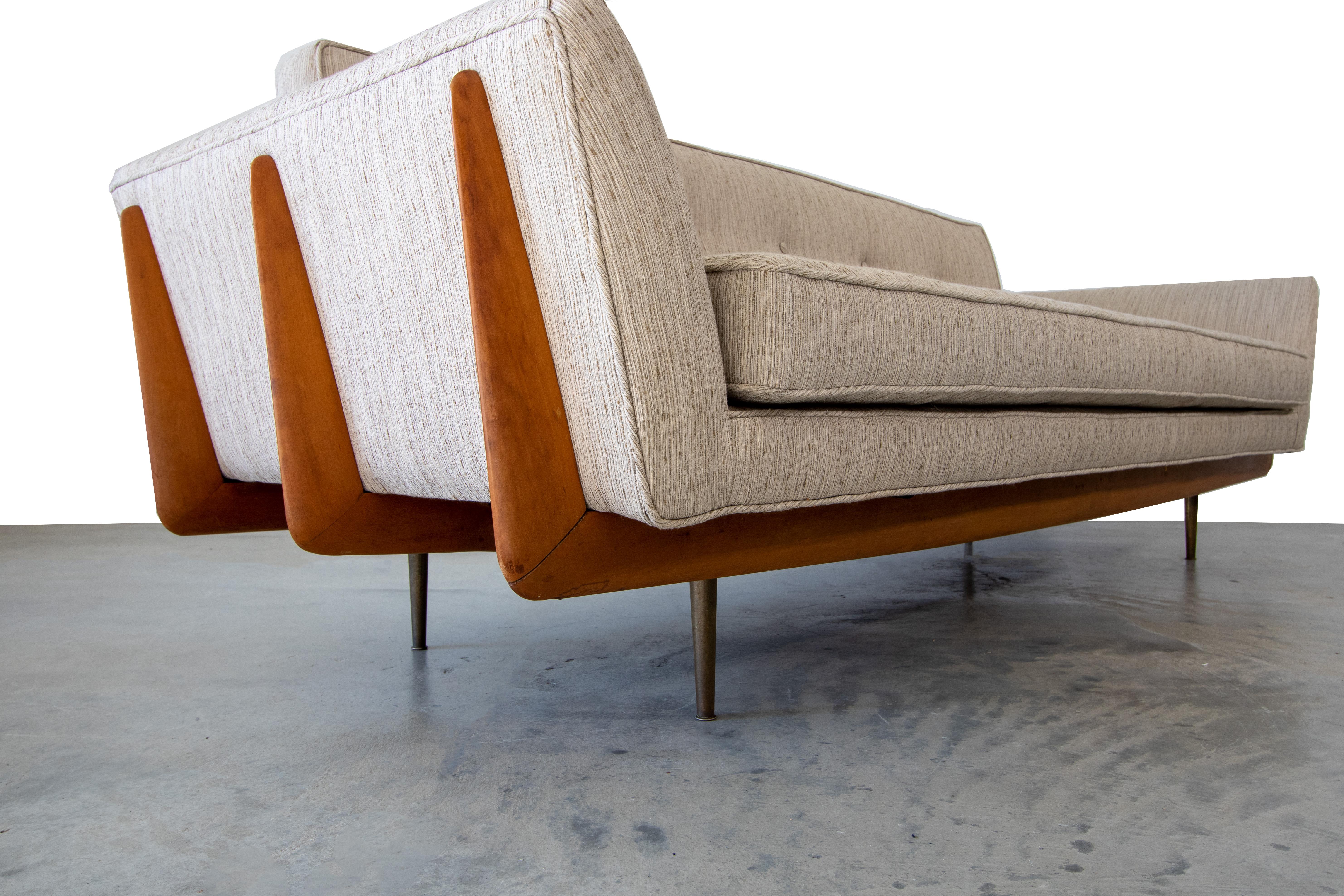 This Mid-Century Modern sofa has it all. Cradle frame with solid wood fin sides, split arms, and brass legs, no design elements were overlooked.. Designed by the team of Robinson and Johnson of Artcraft of Atlanta, little is known about this
