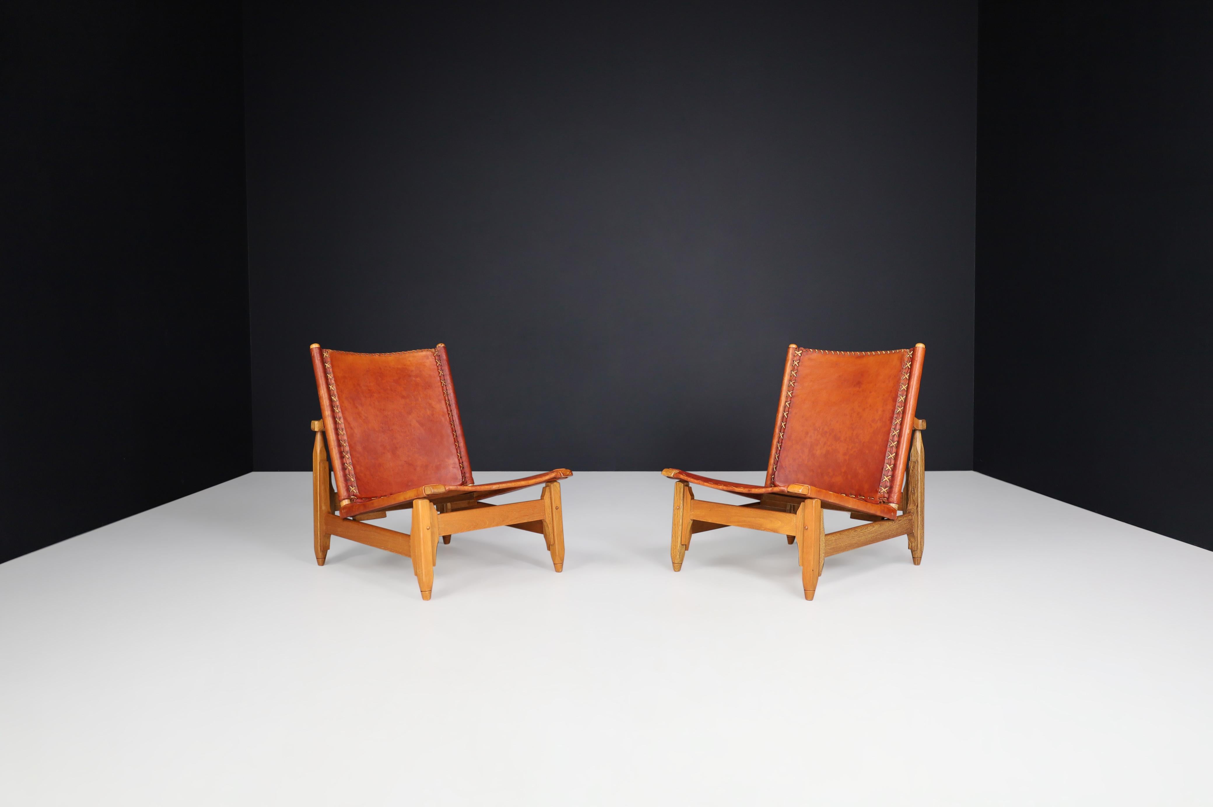 Arte Sano Biermann Cia Inc. Cognac leather hunting chairs, Colombia 1960s

Outstanding pair of two rare hunting lodge chairs designed by Biermann Werner for Arte Sano. These chairs are made of hand-tanned cognac-colored leather. The sturdy wood