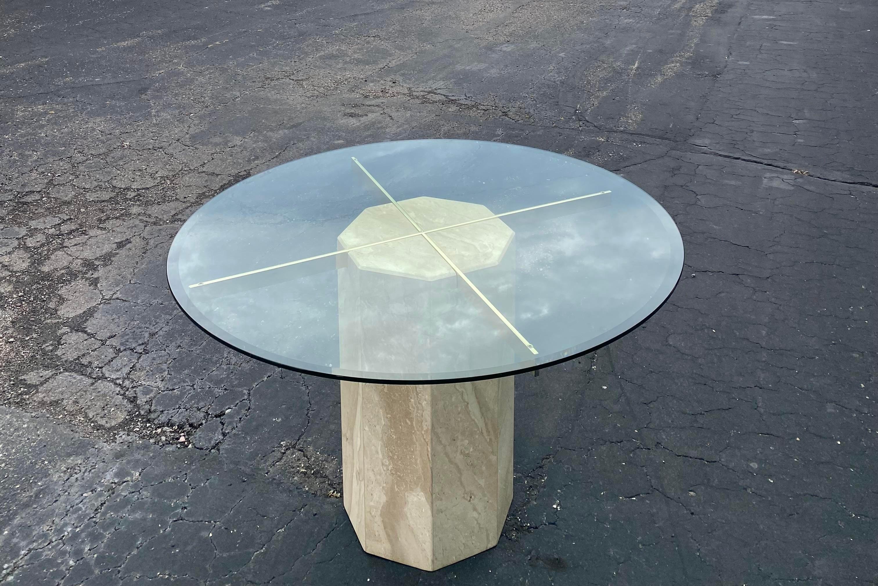 Sleek, Italian marble dining table by Artedi, circa 1980s. Hexagonal marble stone pedestal with brass-plated armatures and a round 48