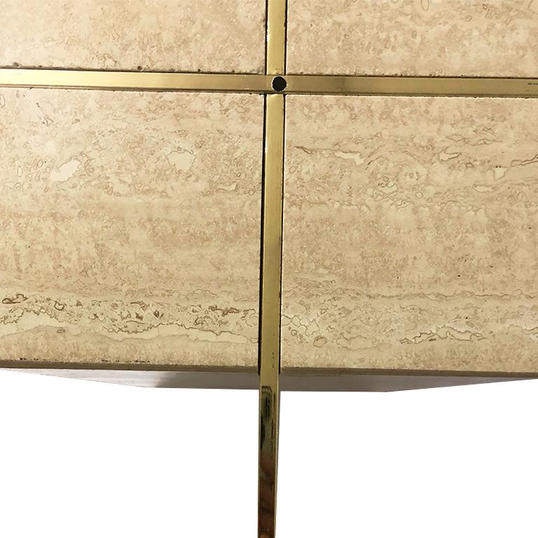 Italian made Travertine base and glass top side or occasional table by Artedi. This table features a square travertine base, satin brass cross X piece which supports a beveled glass tabletop. A wonderful piece for a side table or cocktail table.