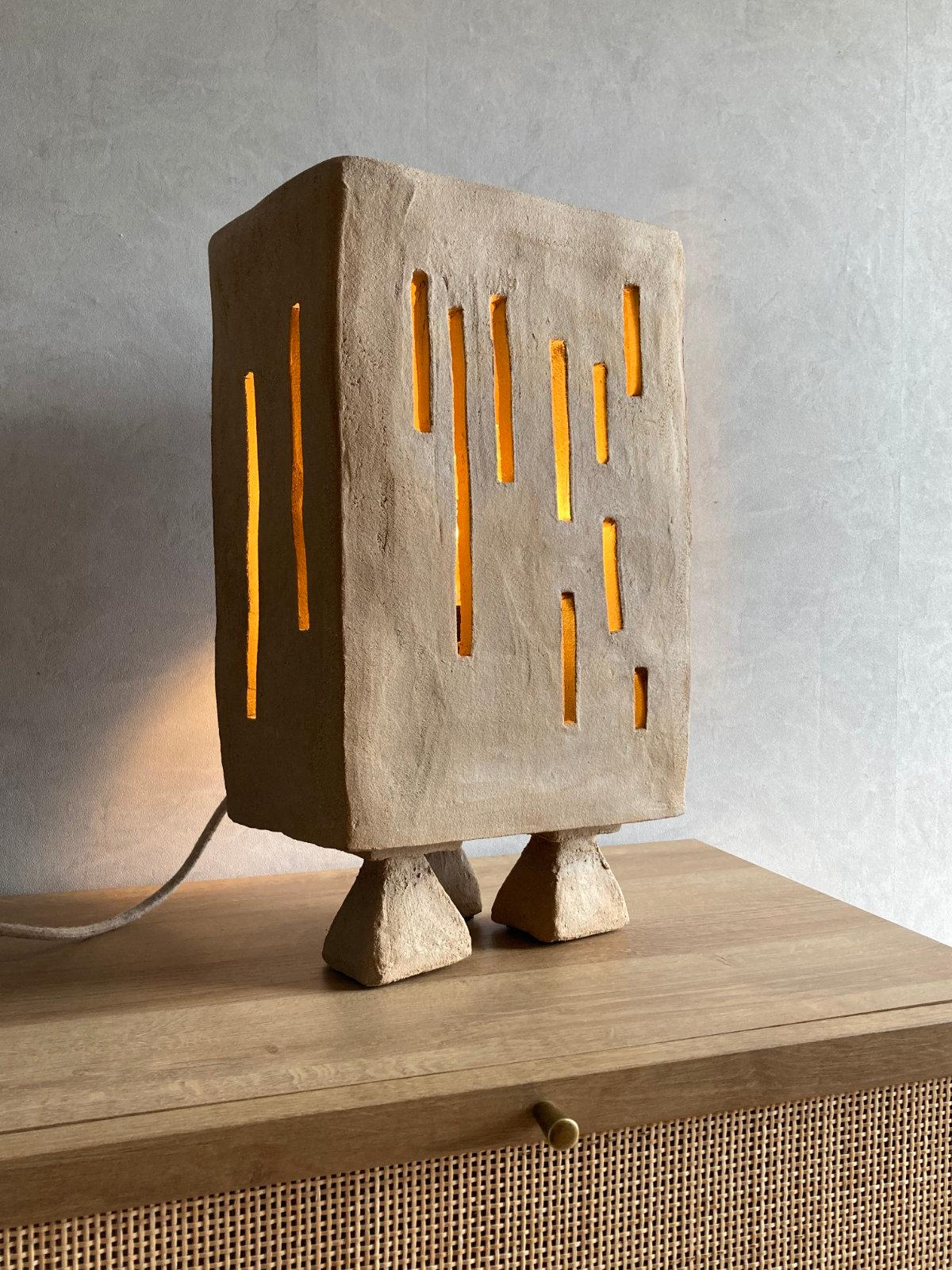 Artefact table lamp by Lea Munsch
Dimensions: W 28 x D 16 x H 49 cm
Materials: Stoneware

Numbered on /20. Each piece is unique with its own personality and marks. There is an opening on the back to slide in a lightbulb.

Sand. As far as the