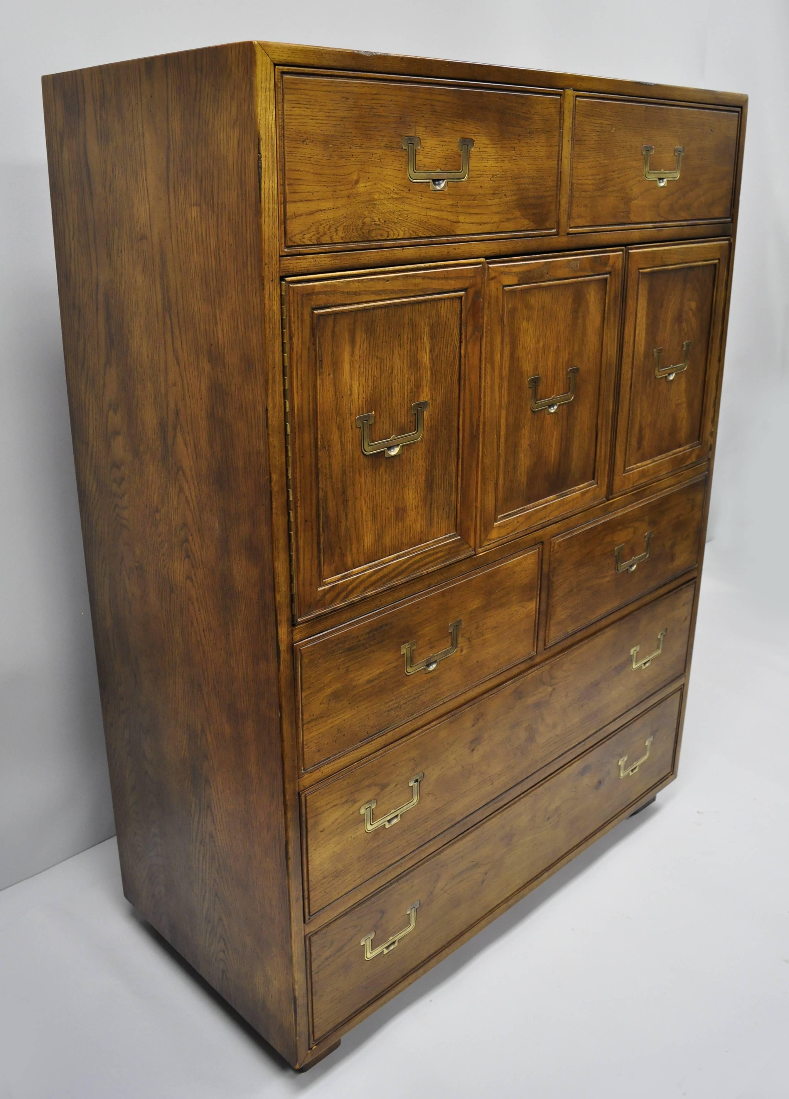 Artefacts by Henredon Campaign style tall dresser. Item features beautiful wood grain, original label, seven dovetailed drawers, swing doors, campaign style inset solid brass hardware, quality American craftsmanship, mid-20th century. Measurements: