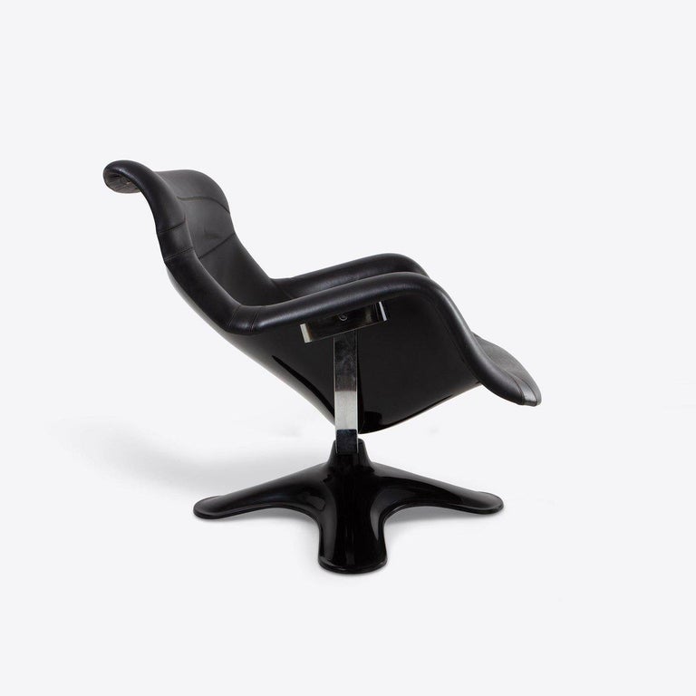 Made in Finland, this chair consists of a black lacquered fiberglass shell, steel base and Sörensen prestige leather upholstered seat in black with PU foam padding. 

Distinct in style and exceptionally comfortable, the Karuselli Lounge Chair