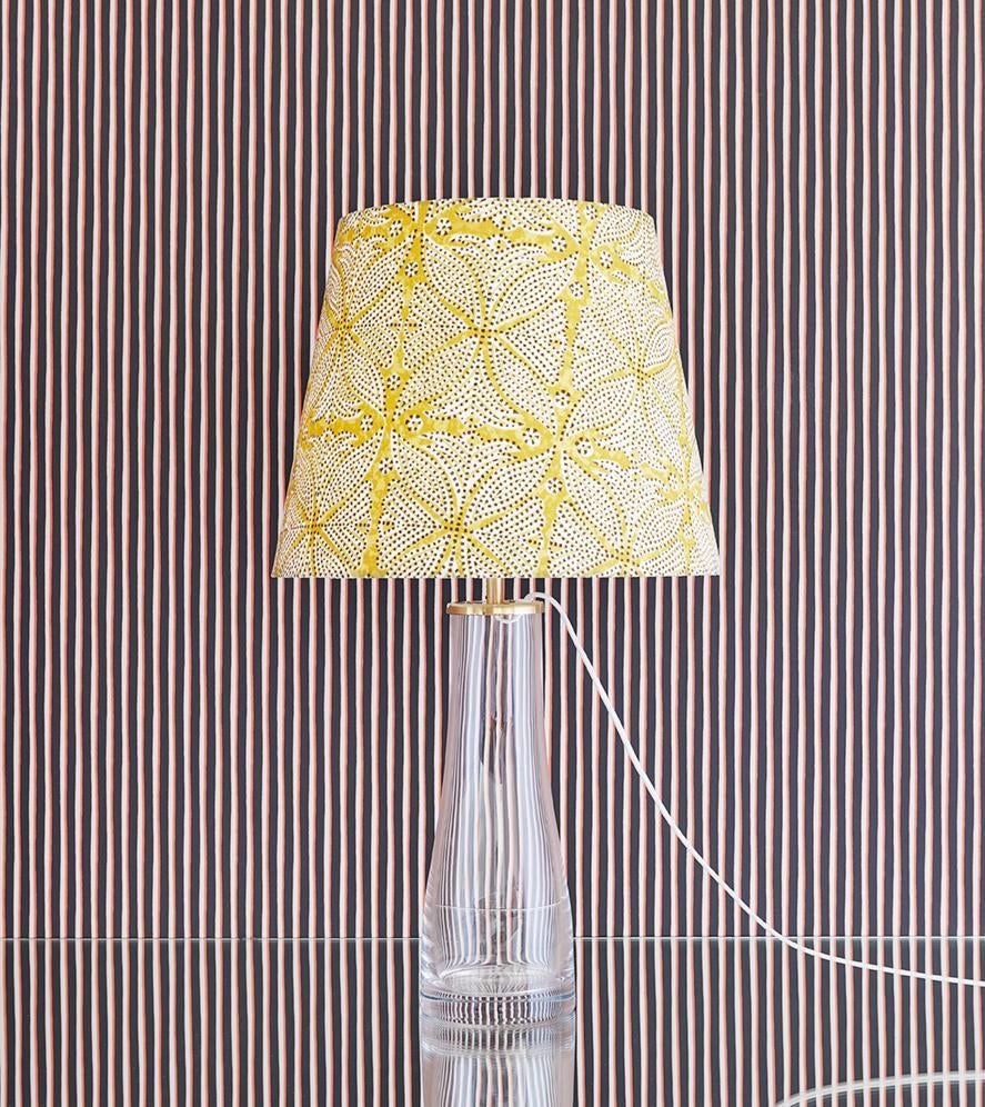 Elegant ‘M510’ table lamp in clear mouth blown glass with brass details and customized linen lampshade by our gallery. The glass base was originally designed in 1950s by Maire Gullichsen.