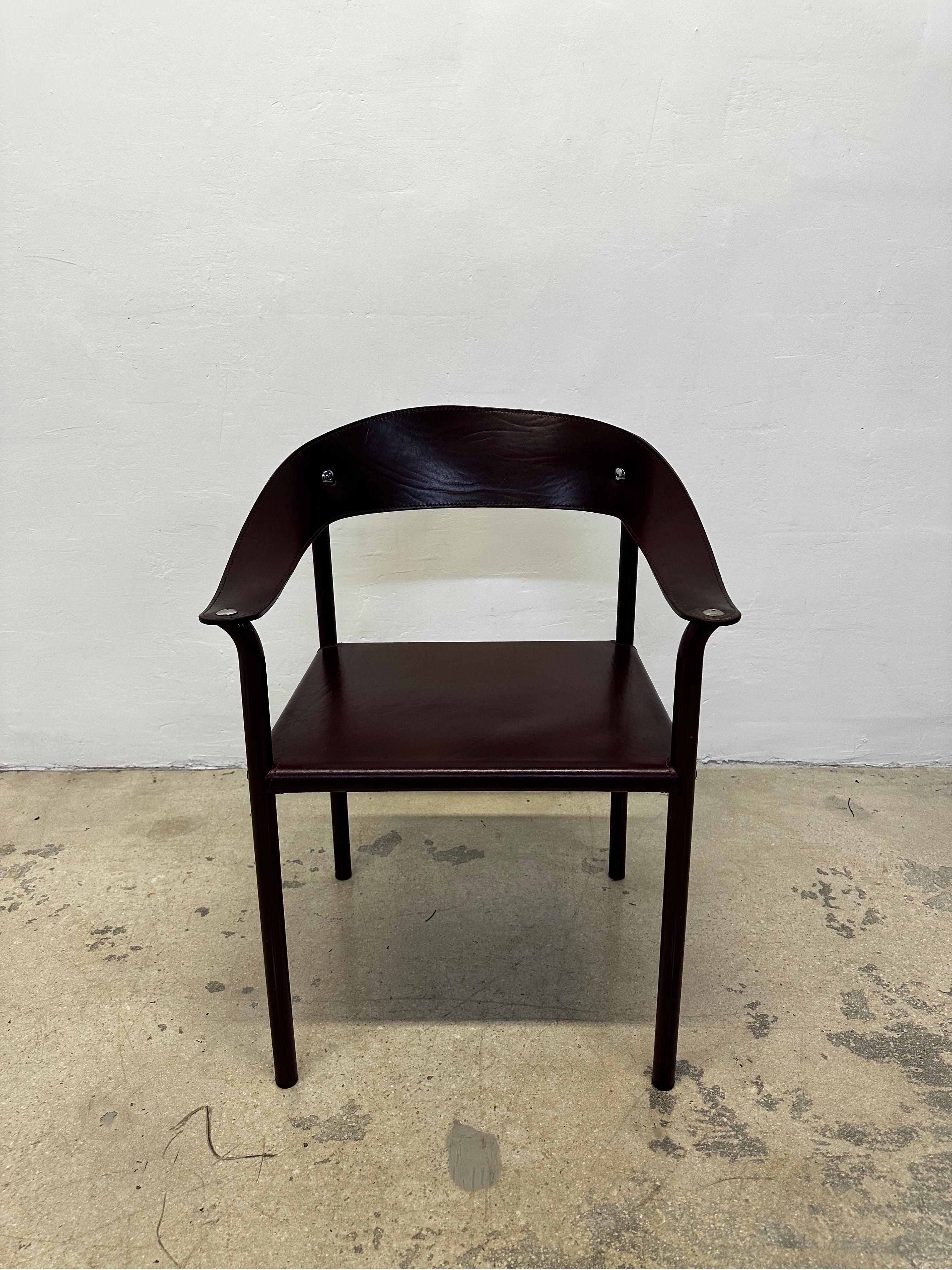 Postmodern leather dining or side chair with steel legs by Artelano, 1980s.  The leather and steel frame are both in a deep maroon color and the leather back and arm rests have chrome hardware.