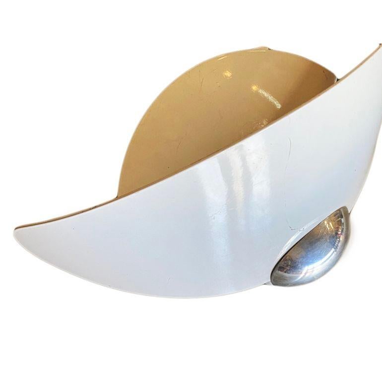 A pair of Aura wall lights made by the famous designers Perry King & Santiago Miranda and produced by Arteluce. Each wall sconce is made of white enameled panels forming a Memphis streamlined look with a chrome sphere accent along the bottom. The