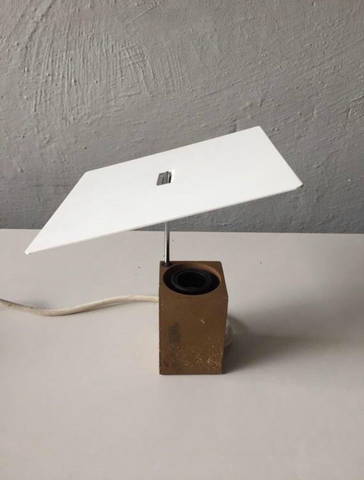 Manufacturer/Designer: Arteluce Milano, Antonio Macchi Cassia, 1970s, Italy
Model no: 610
This spectacular table lamp designed as approach of a sculpture with thin minimalist white metal squared lampshade and a brown stone base.
Its lampshade is