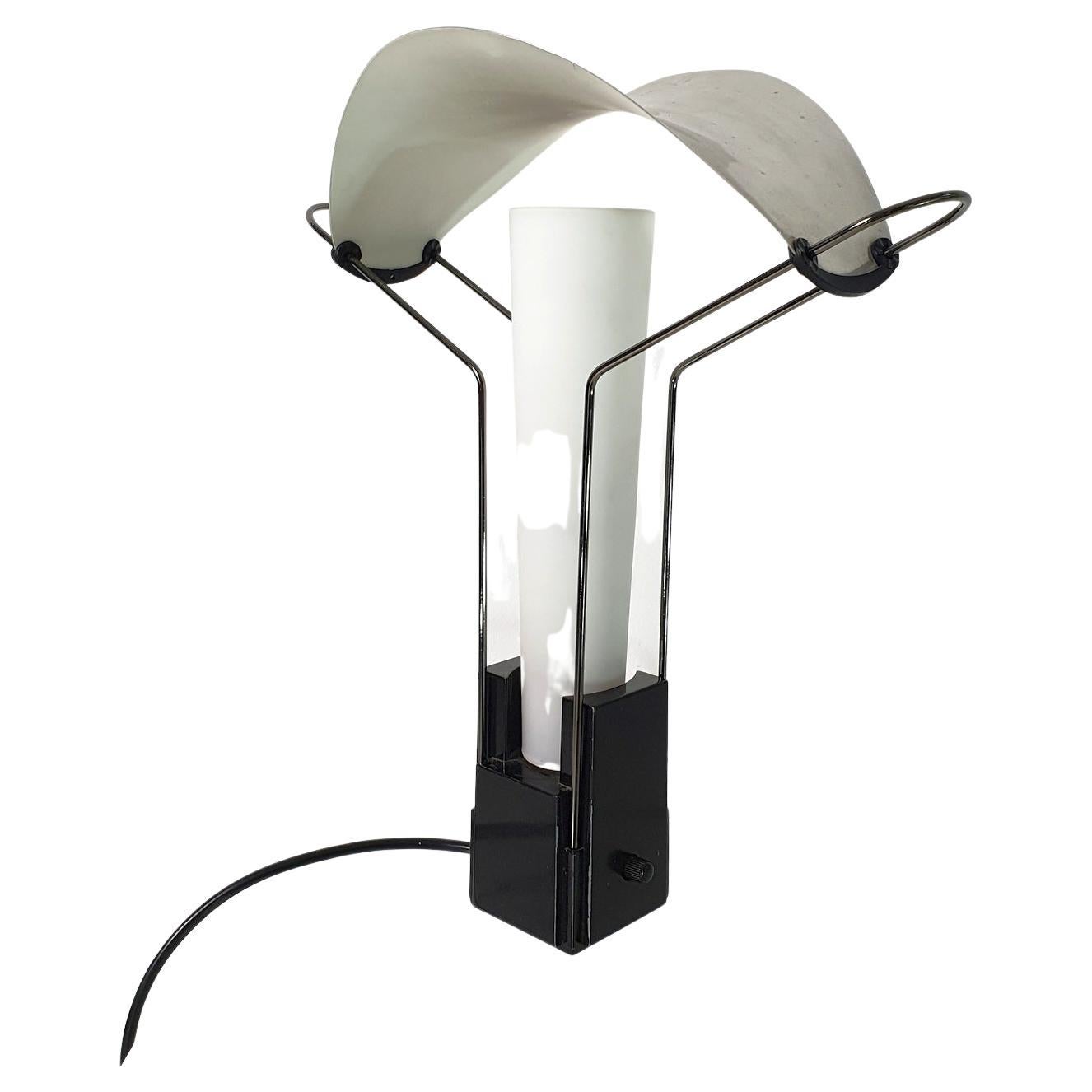 Square black base with a built-in dimmer switch with a polished curved lampshade and opal crystal glass diffuser. Chrome folded & curved rods. Socket works with E14 lightbulbs. European plug.