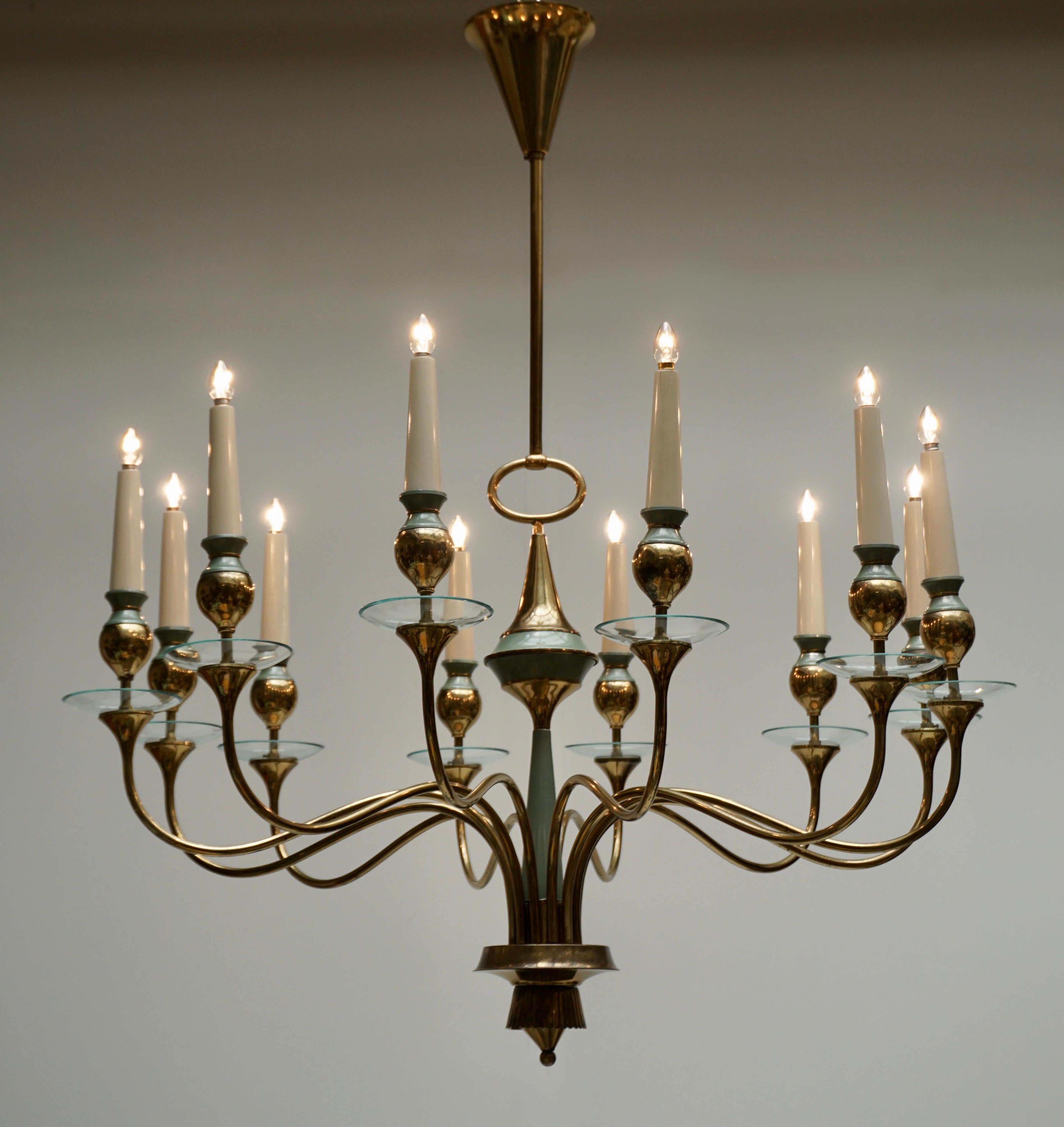 Italian Modern Arteluce style twelve-arm chandelier in brass and glass.Twelve E14 standard sockets.
Original condition. Atomic. 1950s. Sculptural. Rarity. Beautiful when illuminated.
Made in Italy.


   