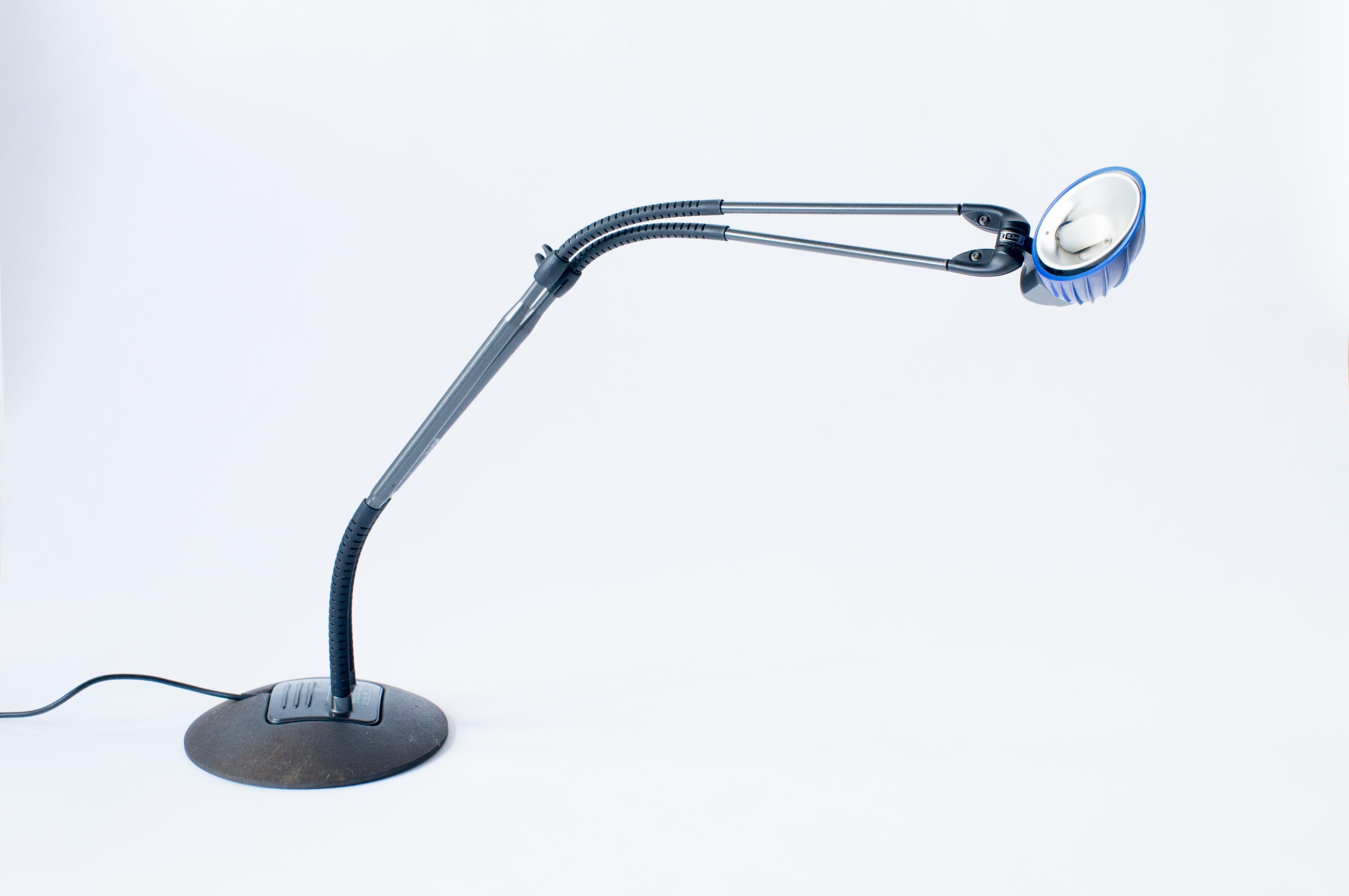 Tango desk lamp designed by Stephan Copeland for Arteluce in 1989
Made of steel. Black and purple color combination. 
Twin arms with spring makes freely direction and position of the lamp.
Maximum height is 110 cm, Maximum width is 110cm, base