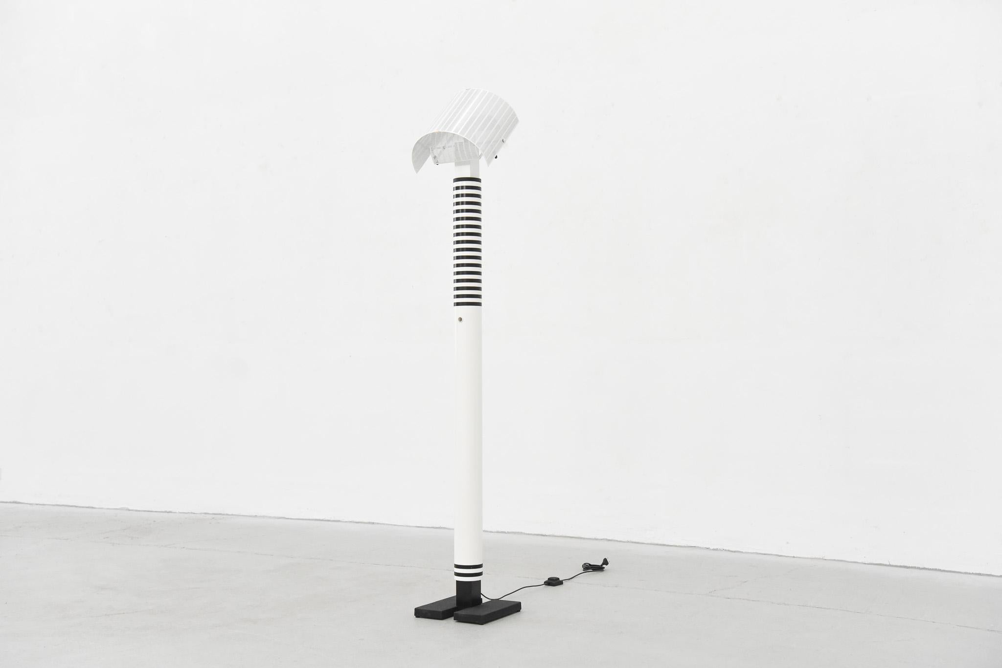 Extremely rare floor lamp by the iconic Italian designer Mario Botta for Artemide. This model is nowadays is only produced as a table lamp and is therefore rarely found.
The design is characterized by a postmodern sculptural appearance, the sheer