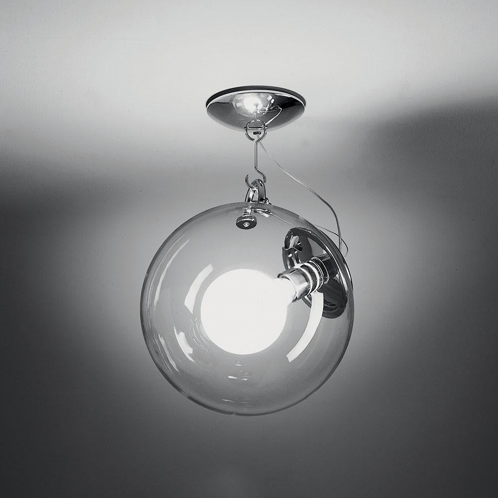 A handblown glass globe of light on a base and stem of polished chrome. Transparent yet created a softly diffused, dimmable light. 

A design statement, the Miconos fixture is designed to complement either modern or more traditional interiors. 
Its