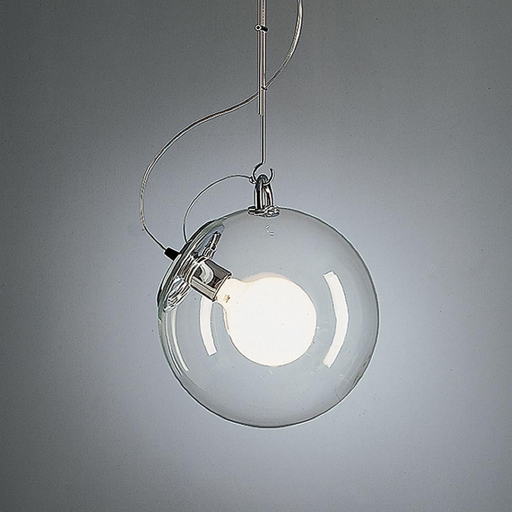 A handblown glass globe of light on a base and stem of polished chrome. Transparent yet created a softly diffused, dimmable light. 

A design statement, the Miconos fixture is designed to complement either modern or more traditional interiors. 
Its