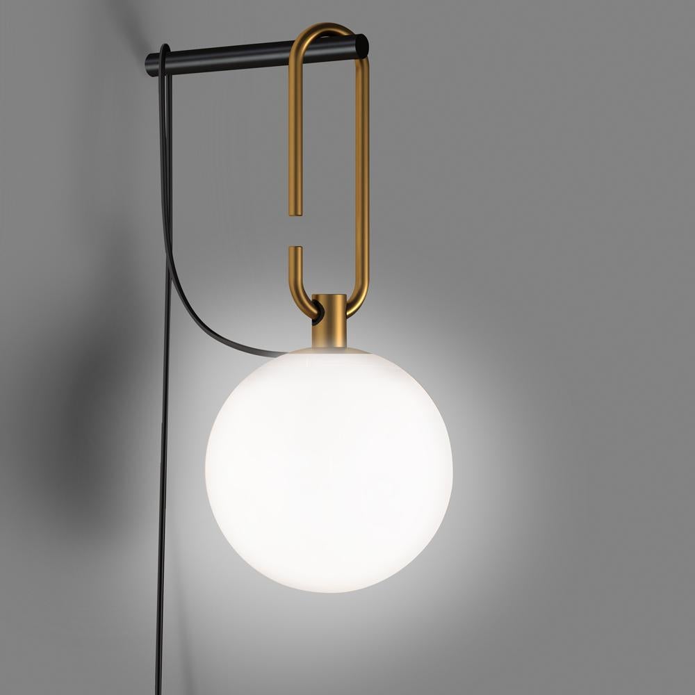 NH is a simple, versatile, practical appliance that can be laid or suspended. A white blown glass sphere slides along a brushed brass ring, which allows it to take different positions and to freely adjust and direct the diffuser. The frame becomes a