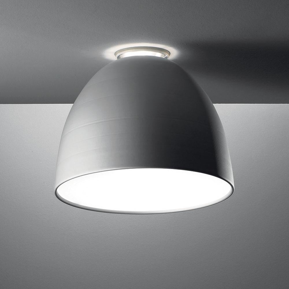 A system for the metamorphosis of light, Nur creates indirect light accompanied by a subtle “halo” effect on the ceiling. Aluminum molded body, polycarbonate lower diffuser, upper cap is transparent borosilicate glass. Nur ceiling is available in