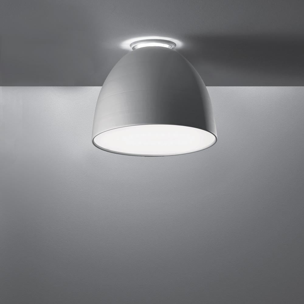 A system for the metamorphosis of light, Nur creates indirect light accompanied by a subtle “halo” effect on the ceiling. Aluminum molded body, polycarbonate lower diffuser, upper cap is transparent borosilicate glass. Nur ceiling is available in