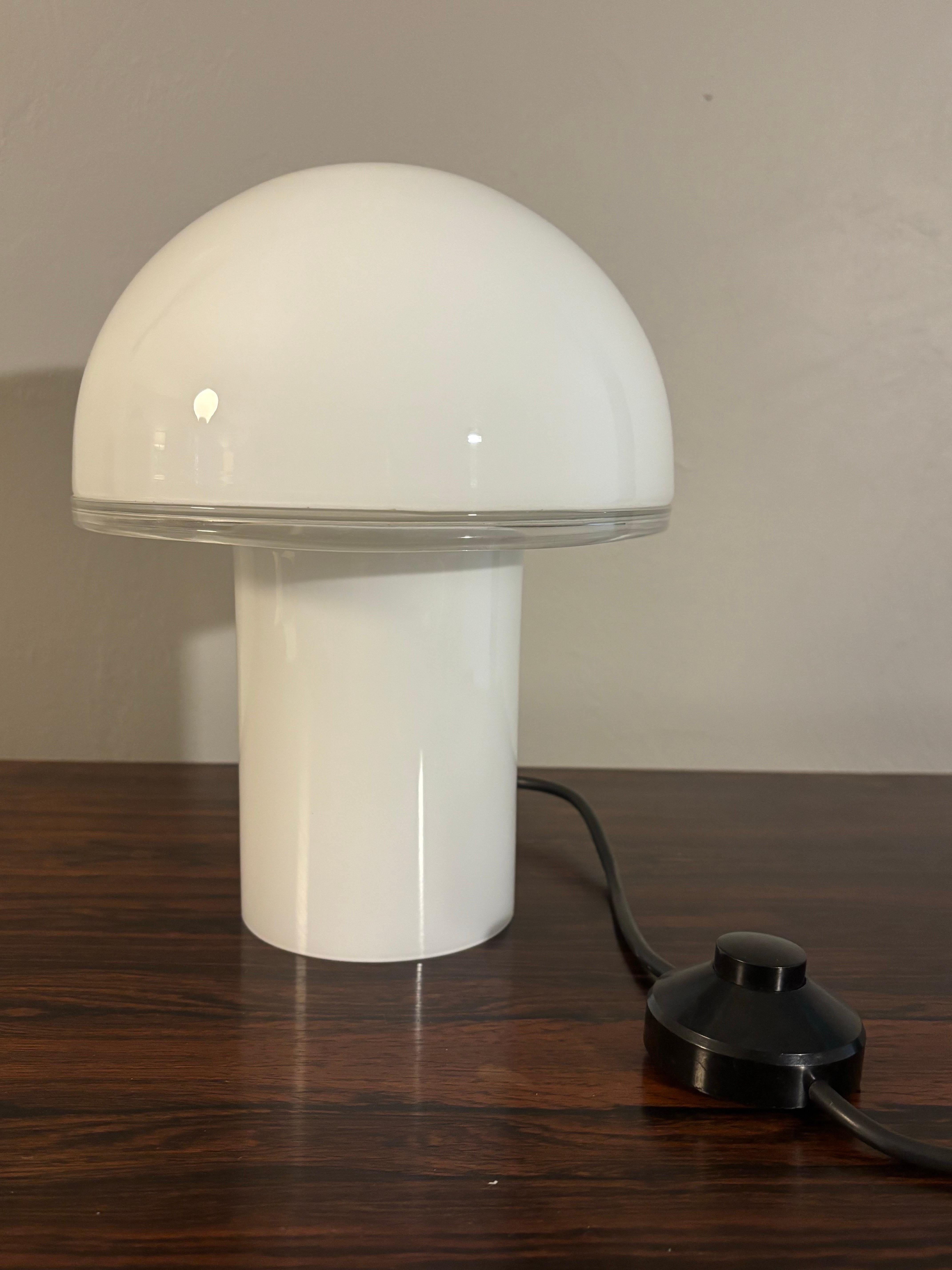 Beautiful, simple and iconic. This Murano glass table lamp was designed by Luciano Vistosi for Artemide in the 1970s. Model name is Onfale and this is the 10” model. 

Onfale is a mushroom shaped table lamp with opaline blown glass that acts as a