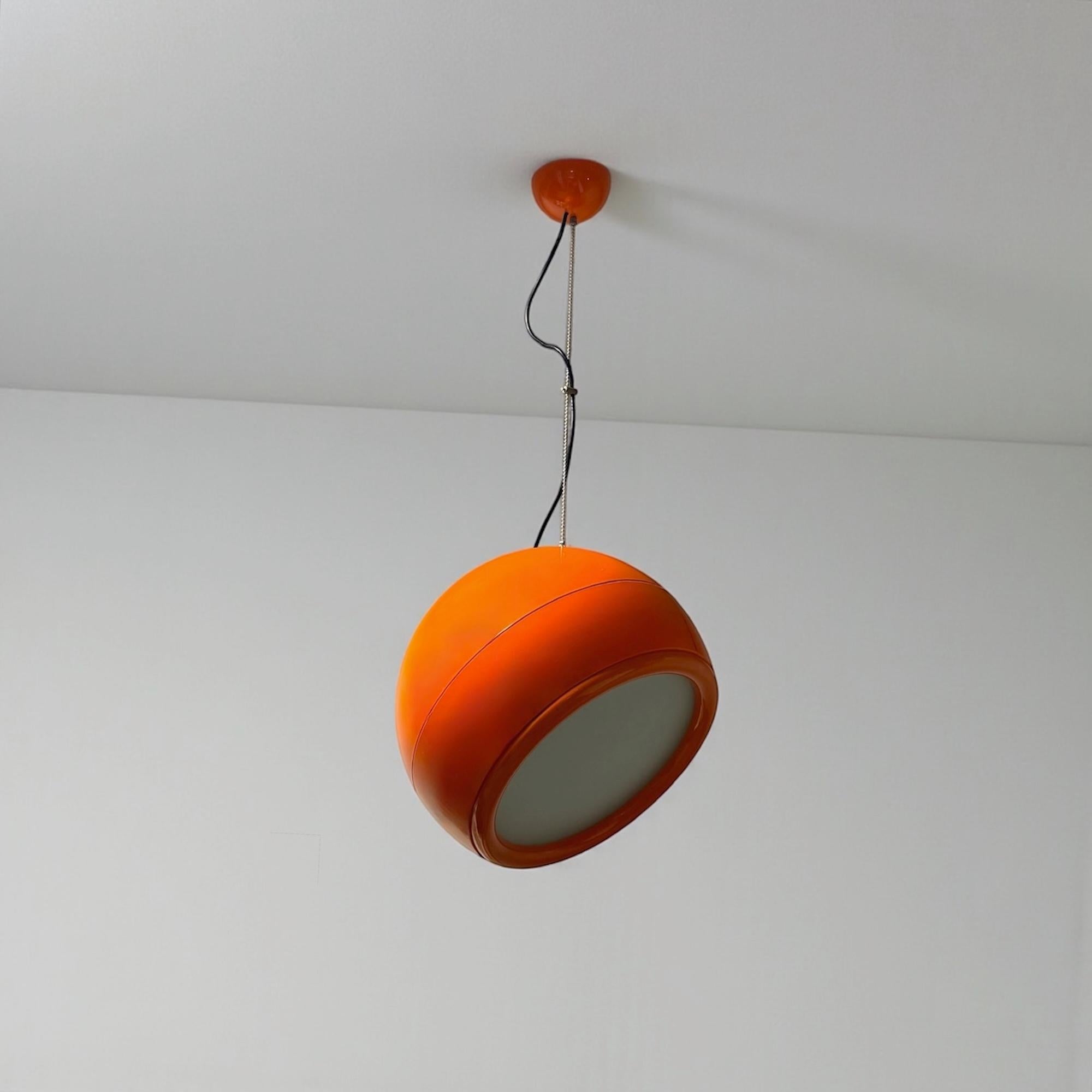 A true icon of Italian Space Age design, this vibrant orange Artemide Pallade hanging lamp was designed by the visionary Studio Tetrarch (Adelaide Bonati, Silvio Bonatti, Enrico De Munari, Carla Federspiel) and produced by Artemide S.p.A., Milan, in