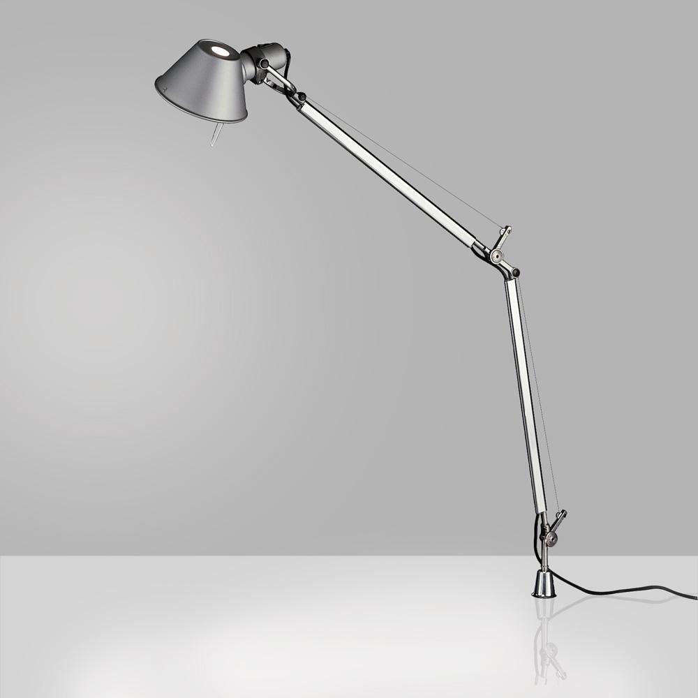“No desk lamp should make you use two hands to position it.” - Michele De Lucchi. A study in balance and movement, the Tolomeo table lamp is designed for a fully adjustable direction of light. Created for Artemide in 1987 by Michele De Lucchi and