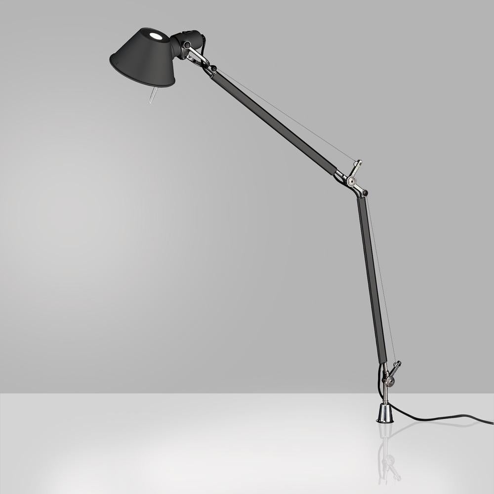 “No desk lamp should make you use two hands to position it.” - Michele De Lucchi. A study in balance and movement, the Tolomeo table lamp is designed for a fully adjustable direction of light. Created for Artemide in 1987 by Michele De Lucchi and