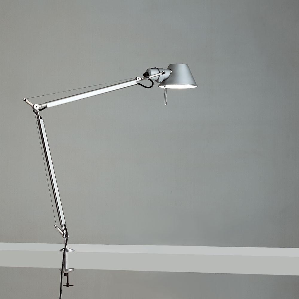 “No desk lamp should make you use two hands to position it.” - Michele De Lucchi. A study in balance and movement, the Tolomeo table lamp is designed for a fully adjustable direction of light. Created for Artemide in 1987 by Michele De Lucchi and