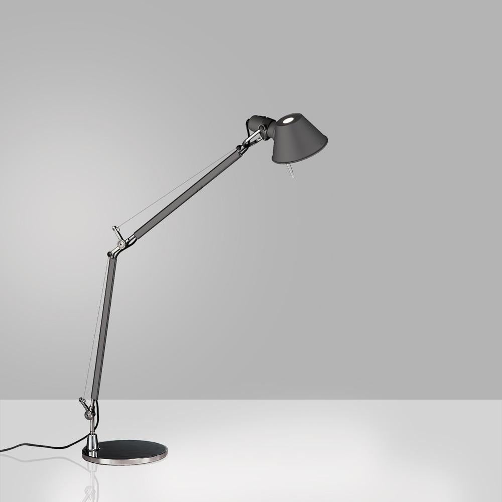 “No desk lamp should make you use two hands to position it.” Michele De Lucchi A study in balance and movement, the Tolomeo table lamp is designed for a fully adjustable direction of light. Created for Artemide in 1987 by Michele De Lucchi and