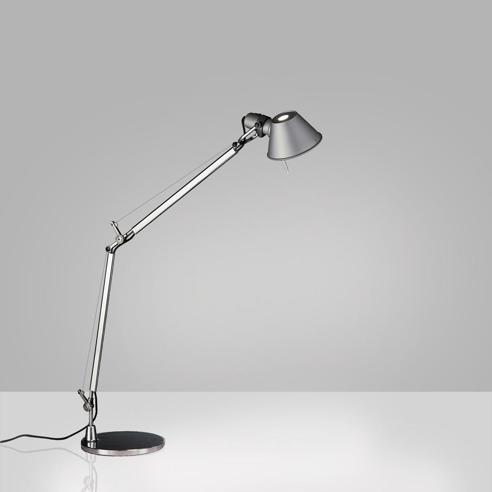 “No desk lamp should make you use two hands to position it.” Michele De Lucchi A study in balance and movement, the Tolomeo table lamp is designed for a fully adjustable direction of light. Created for Artemide in 1987 by Michele De Lucchi and