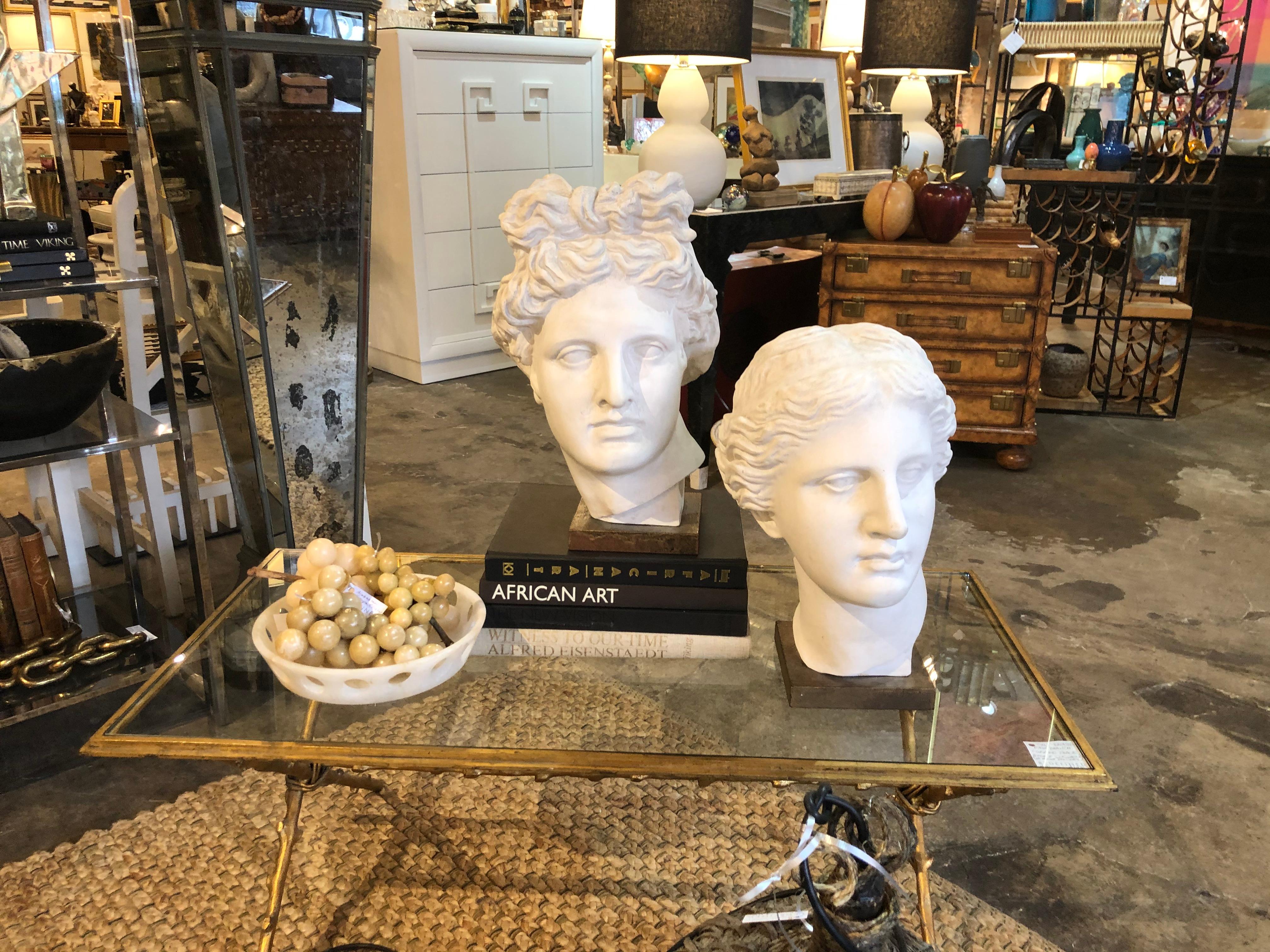 (Two) Artemis Diana and Apollo Greek God plaster busts mounted on wood plinths.