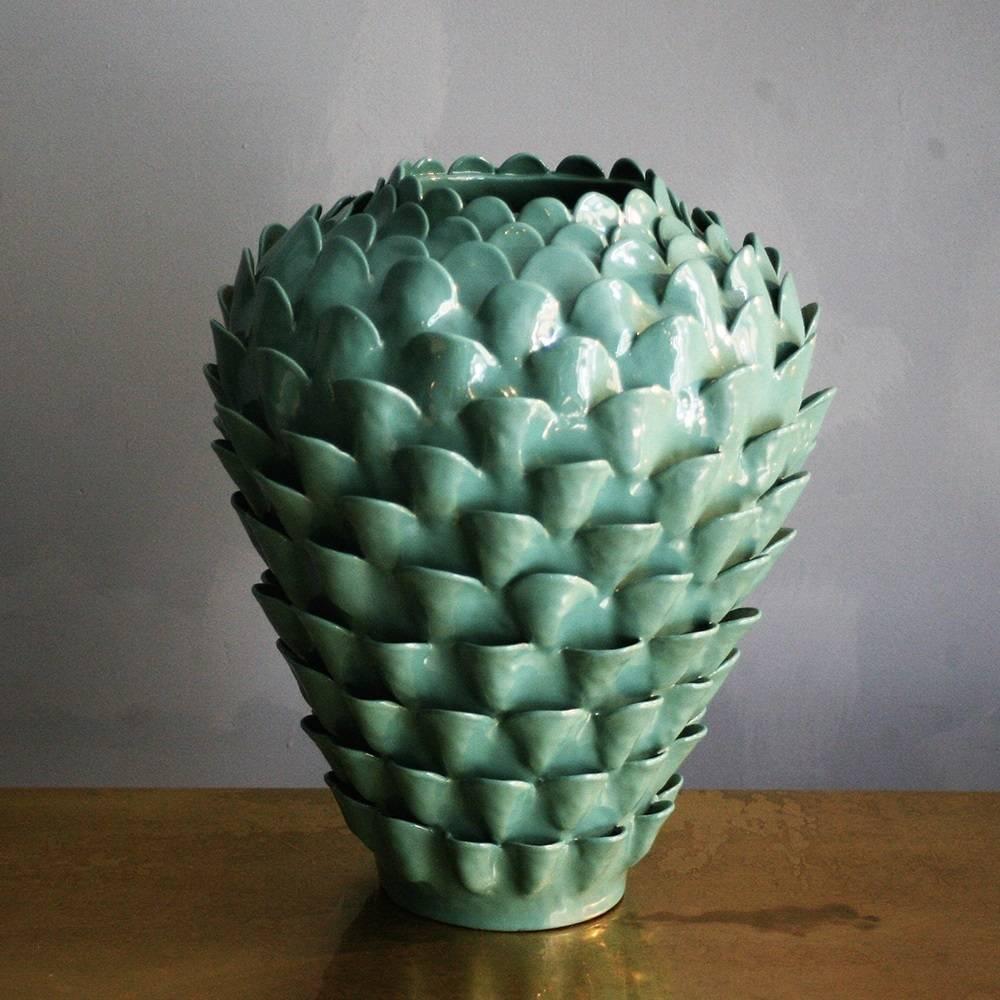 The bright turquoise glaze of this striking terracotta vase brings the large, raised fish scale pattern into focus. Part of the Artemisia collection, this piece is entirely handmade using the ancient colombino technique. Each piece is signed and