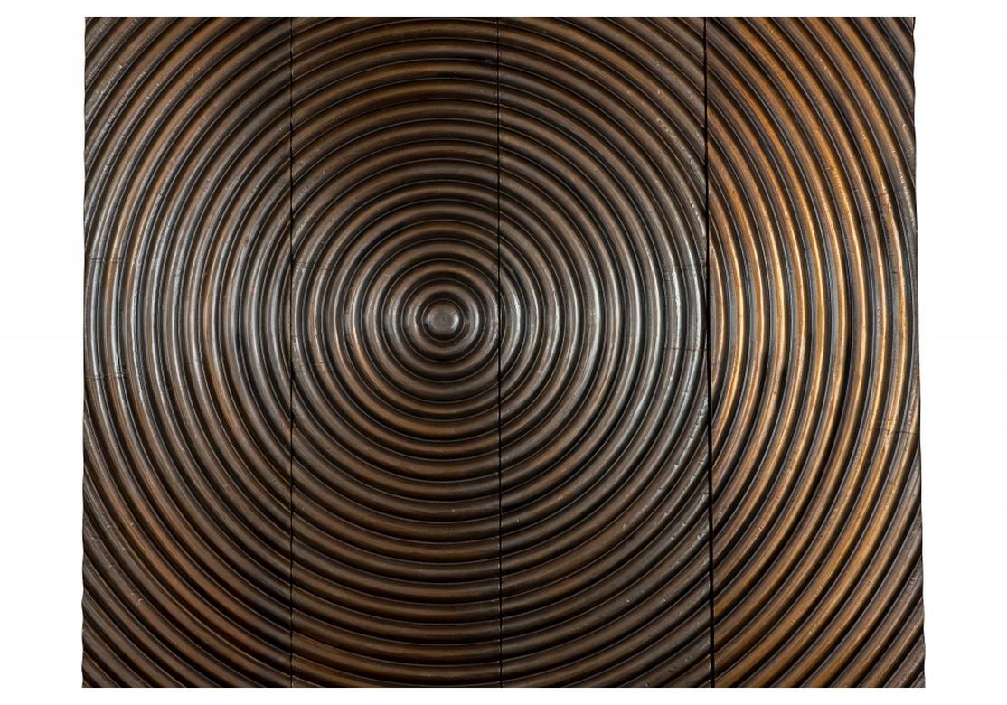 Arteriors brass clad wood wall panels with a deep epicenter design. The panels with a raised center and concentric circles across the four panels. May also be used separately for great effect. Labels on reverse: “Arteriors” and “Made in India”.