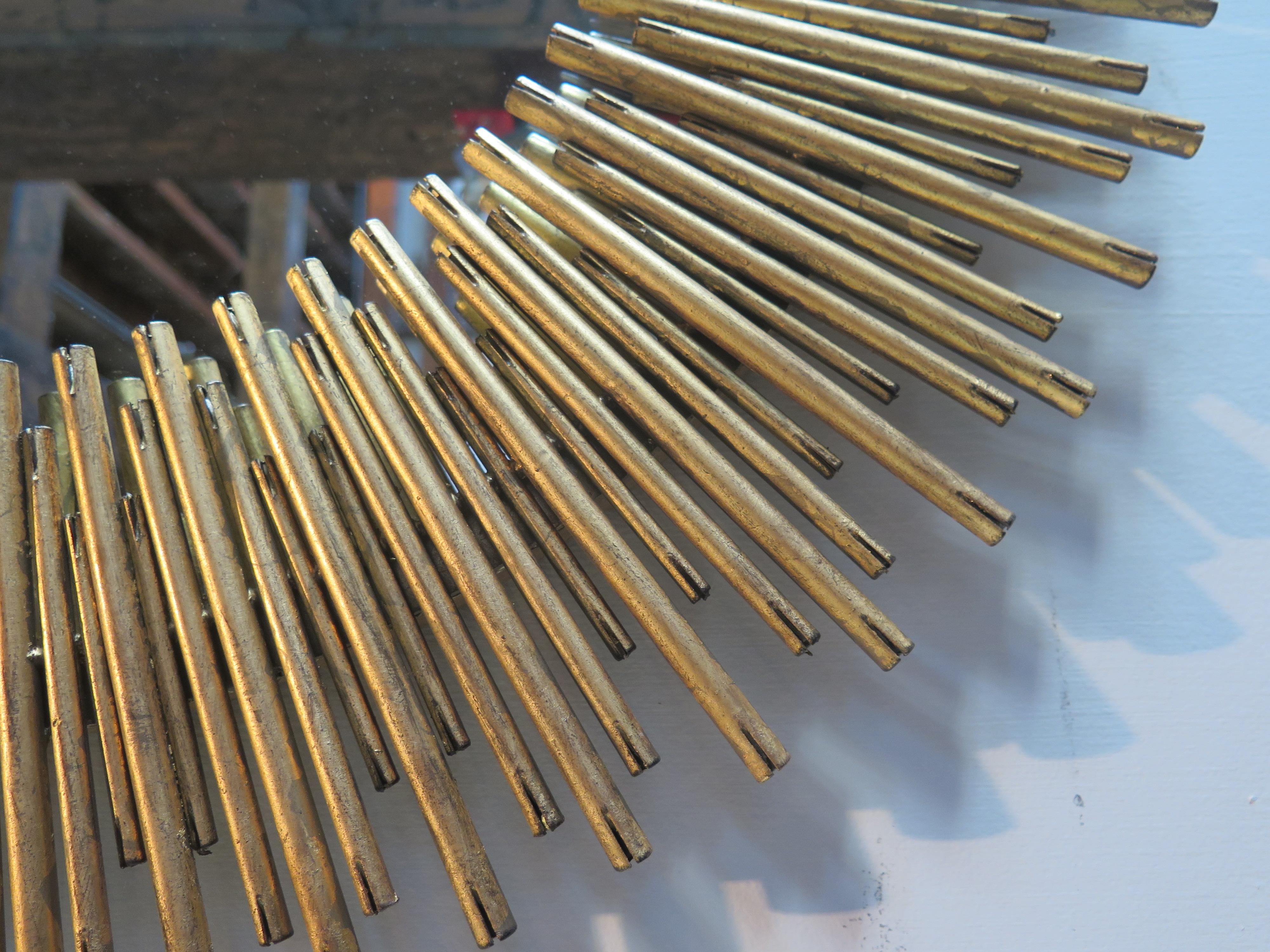 Arteriors Prescott gold oval mirror with rim of iron reeds.