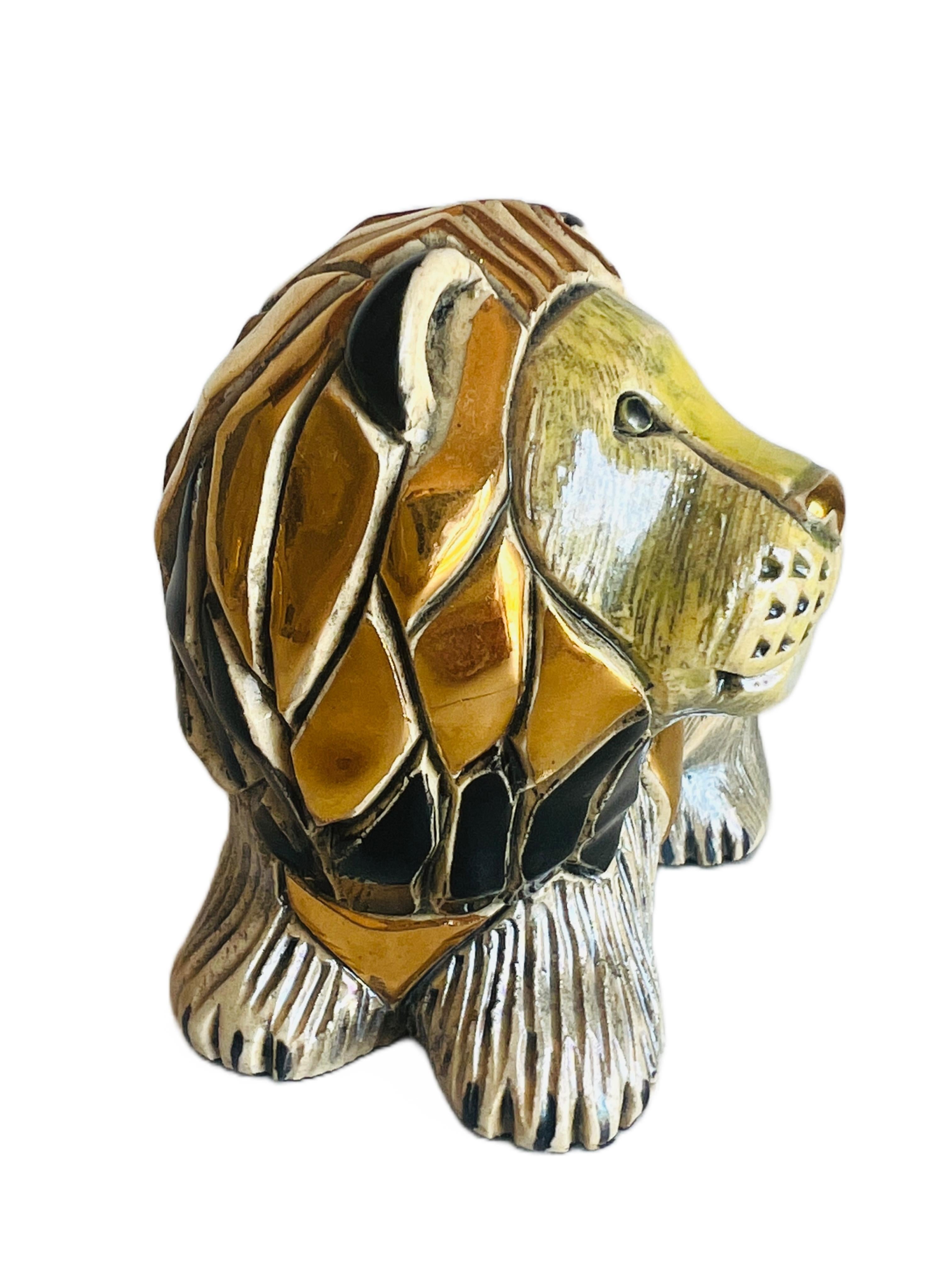 This lovely lion figurine was hand carved and decorated with platinum and gold by the Rinconada artists in Uruguay. It is part of the Silver Anniversary Collection #709 and is now retired. 

Size: 4